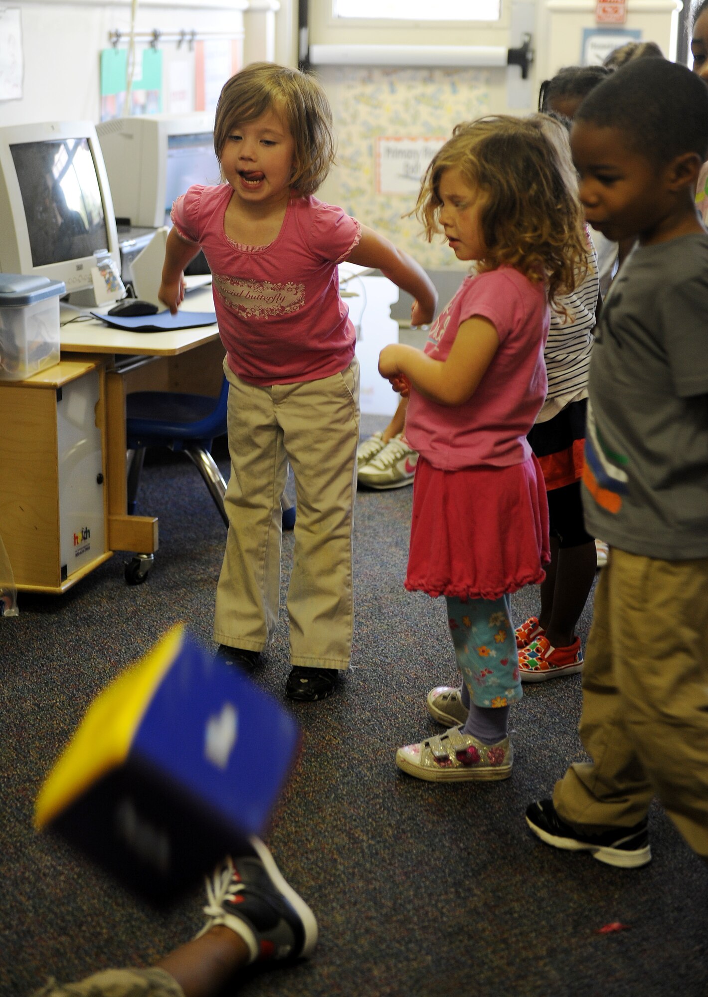 Children from the Child Development Center, rolls a colored block during a fitness exercise April 25, 2012 at Scott Air Force Base, Ill.  Members from the Health and Wellness Center (HAWC) trained the children on the importance of physical fitness, and used colored blocks to determine which exercise was going to be performed. (U.S. Air Force photo/Airman 1st Class Divine Cox)