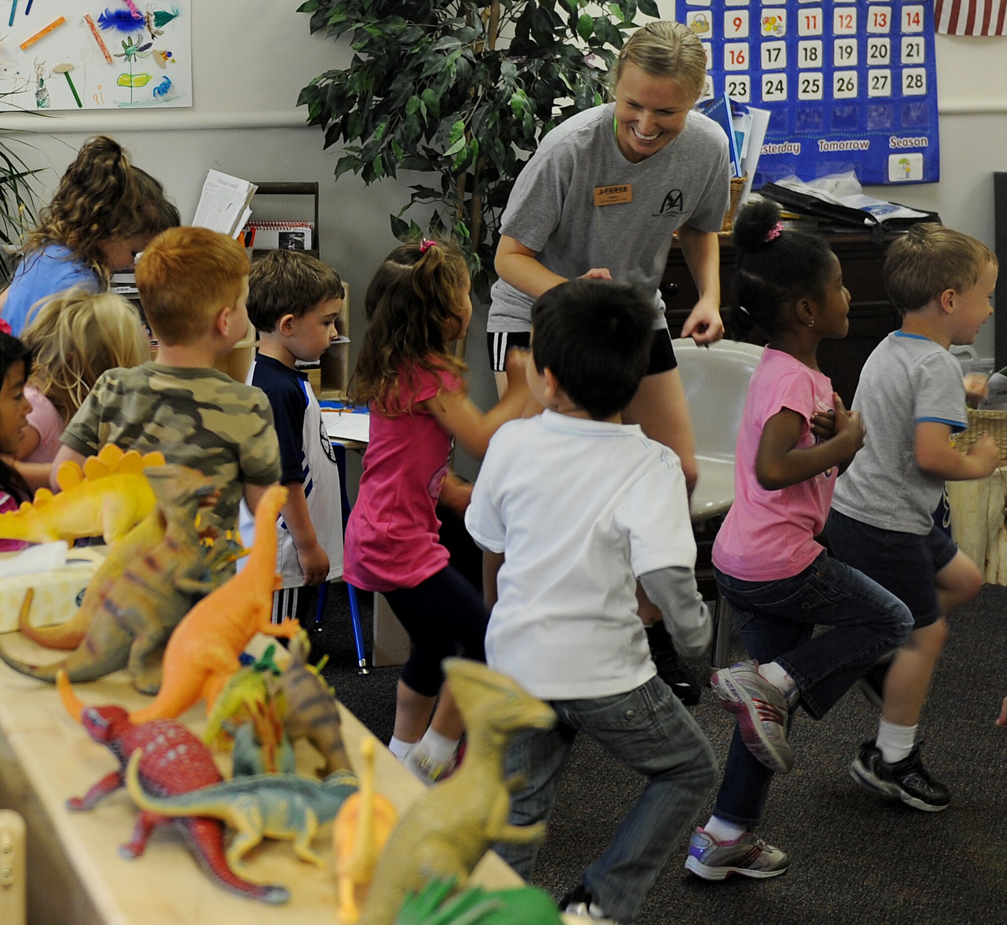 Laura Weighlein, Health and Wellness Center health technician, teach the children of the Child Development Center about fitness April 25, 2012 at Scott Air Force Base, Ill.  April is the Month of the Military Child and Physical Fitness Month. (U.S. Air Force photo/Airman 1st Class Divine Cox)