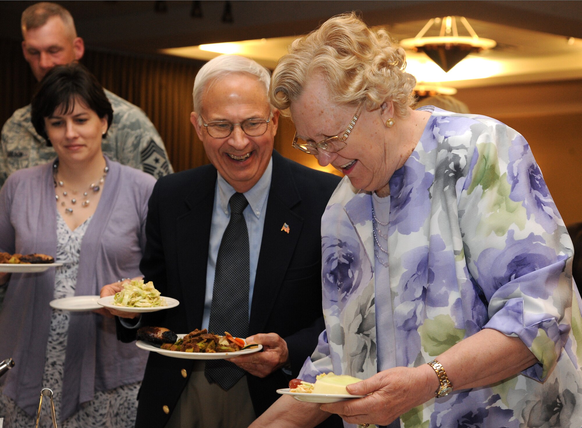 Mr. Jim Bradshaw, honorary ambassador number six to Grand Forks Air Force Base, waits in line for food with guests and Airmen on April 26, 2012, on Grand Forks Air Force Base, N.D.  (U.S. Air Force photo by Airman 1st Class Navarro)