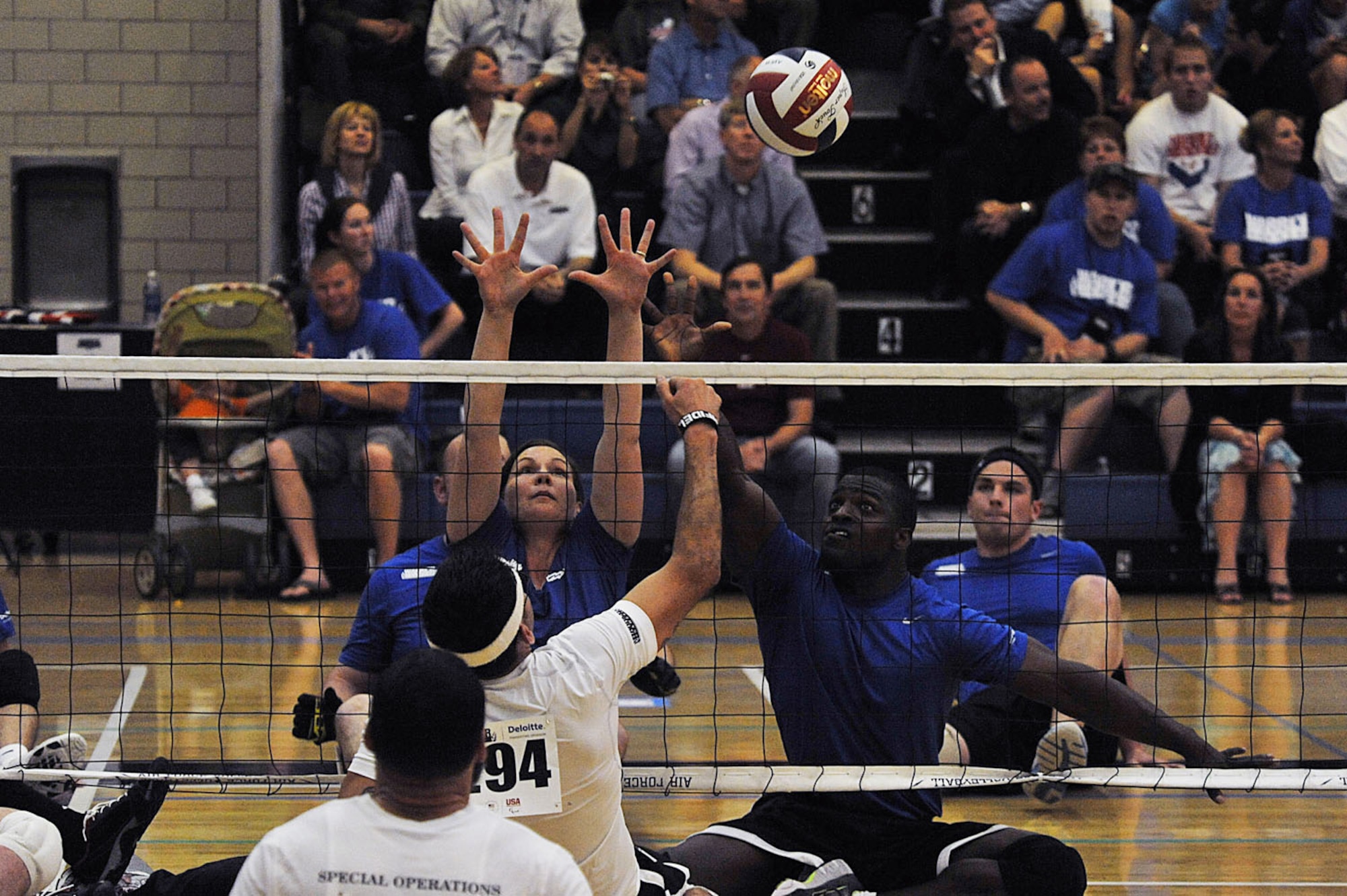 Retired Staff Sgt. Michael Sanders (back right) and Stacy Pearsall, both with the Air Force team, attempt to block the ball during a sitting volleyball game against the Special Operations team at Warrior Games 2012 at the U.S. Air Force Academy in Colorado Springs, Colo., May 1, 2012. Air Force won 41-14.  (U.S. Air Force photo/Val Gempis)