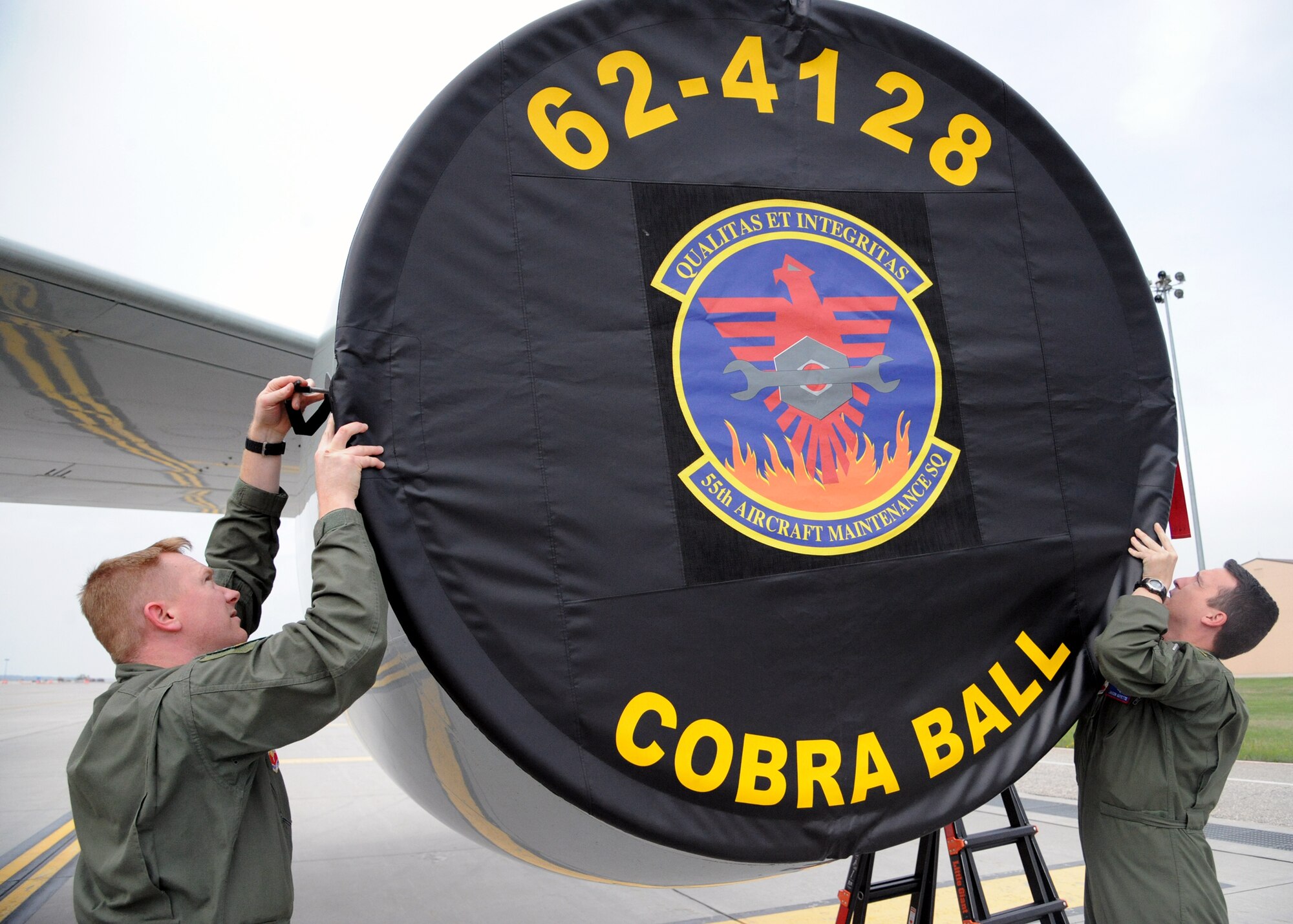 From left: Capt. Jason Guyette and Tech. Sergeant Zach Gronau – from Offutt Air Force Base, Neb. - secure their aircraft after arriving at Grand Forks Air Force Base, N.D., on May 1, 2012. About 100 Offutt personnel were diverted to Grand Forks to avoid dangerous weather conditions at their home base. (U.S. Air force photo by Senior Airman Amber Bennett)