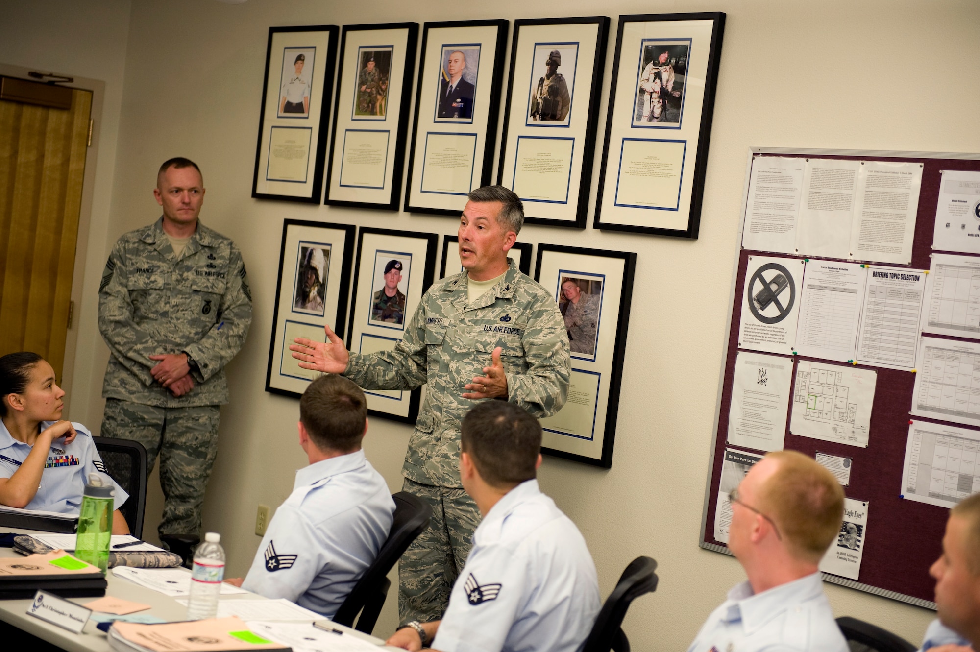 U.S. Air Force Col. Kit Lambert, 99th Security Forces Group commnader, presents the Fallen Defenders Legacy Project to Defender Flight, May 2, 2012, at Nellis Air Force Base, Nev.  Lambert talked about each Airman that was killed in action, giving background information on their lives and how they died in combat. (U.S. Air Force photo by Staff Sgt. William P.Coleman)
  

