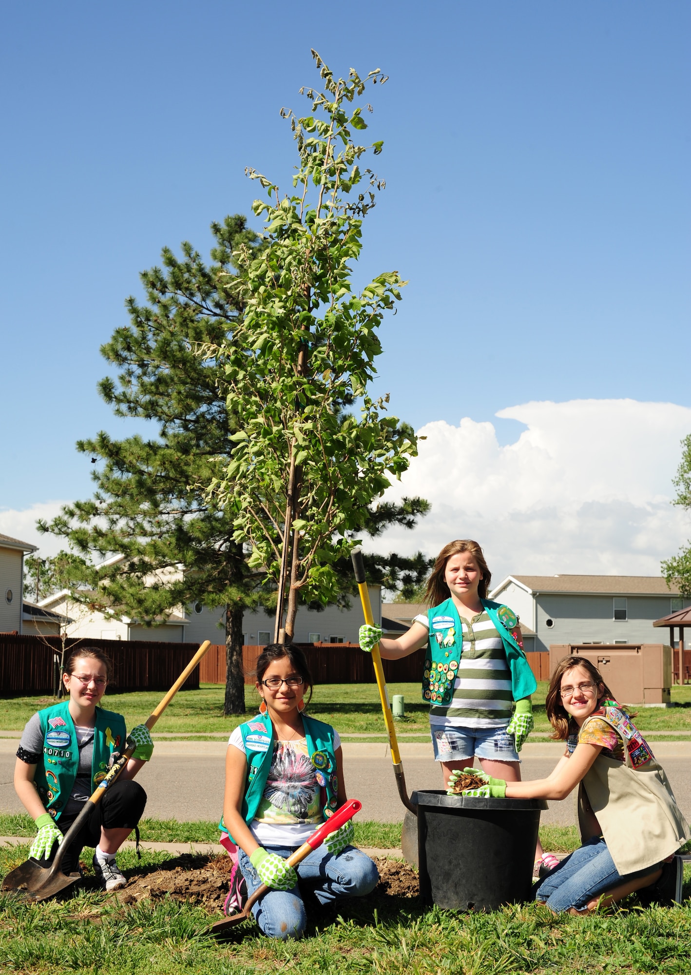 Troop members from Girl Scout Troop 40710 celebrate Arbor Day by assisting with the planting of three trees at the school-age program facility April 28, 2012, McConnell Air Force Base, Kan. Arbor Day was founded in 1872 and is celebrated across the nation by planting trees. (U.S. Air Force photo/ Senior Airman Courtney Witt)
