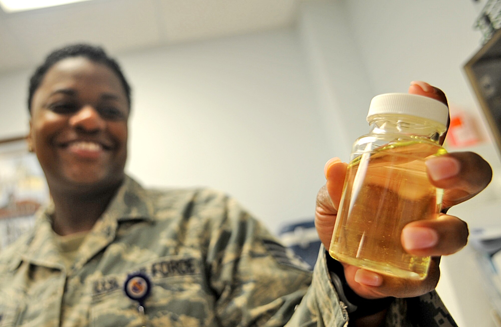 U.S. Air Force Staff Sgt. Sherring Goodwin inspects a water sample positive for bacteria on Seymour Johnson Air Force Base, N.C., May 1, 2012. A jar of water that tested positive for bacteria is kept in the bioenvironmental water lab for training and comparative purposes. Goodwin, 4th Aerospace Medicine Squadron environmental surveillance non-commissioned officer in charge, hails from Crossett, Ark. (U.S. Air Force photo/Airman 1st Class Aubrey Robinson/Released)