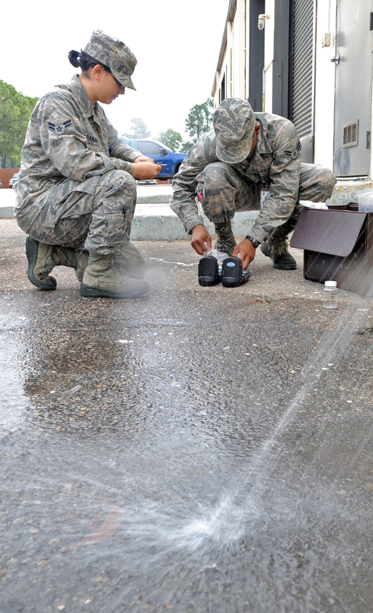 U.S. Air Force Airmen 1st Class Andrea Spanjer and Oshane Wint test the chlorine and pH levels in water samples collected on Seymour Johnson Air Force Base, N.C., May 1, 2012. Bioenvironmental apprentices require at least 14 on-the-job training hours before they are allowed to conduct bacteria testing on their own. Spanjer, 4th Aerospace Medicine Squadron bioenvironmental apprentice, hails from Seattle. Wint, 4th AMDS bioenvironmental engineer apprentice, hails from Englewood, N.J. (U.S. Air Force photo/Airman 1st Class Aubrey Robinson/Released)