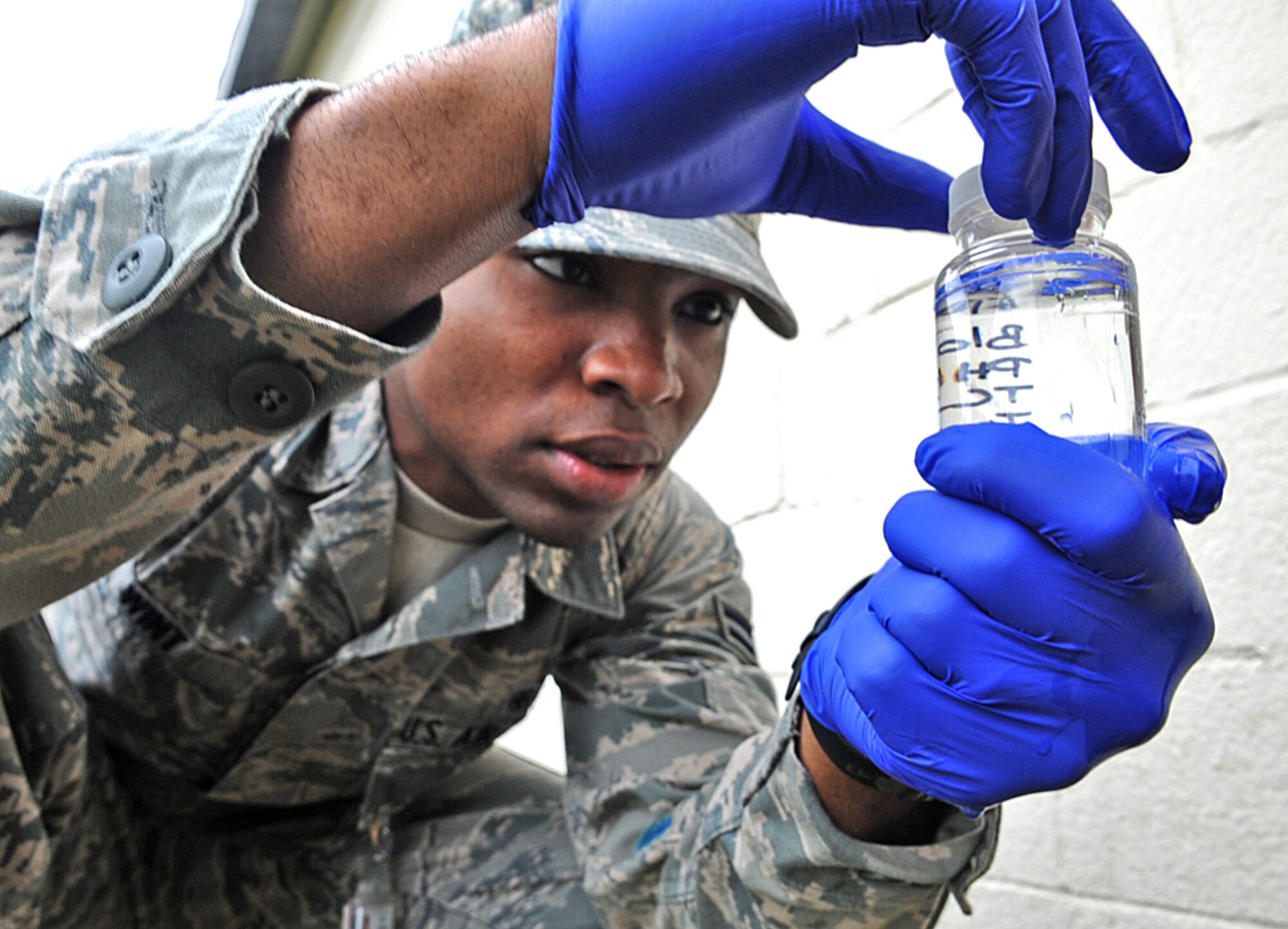 U.S. Air Force Airman 1st Class Oshane Wint collects a water sample for testing on Seymour Johnson Air Force Base, N.C., May 1, 2012. As part of their preventative health mission, 4th Aerospace Medicine Squadron bioenvironmental apprentices must conduct 14 monthly quality control tests on different water sources around base. Wint, 4th AMDS bioenvironmental apprentice, hails from Englewood, N.J. (U.S. Air Force photo/Airman 1st Class Aubrey Robinson/Released)