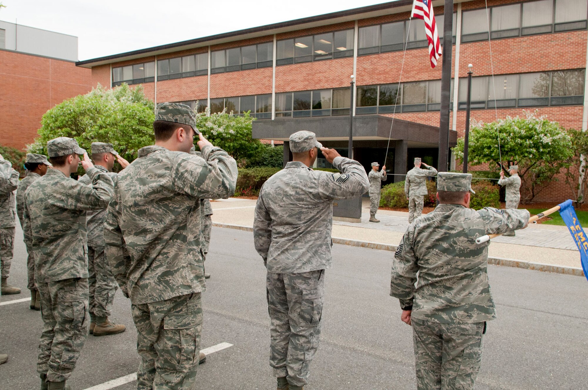 HANSCOM Air Force Base, Mass. - Members of the Electronic Systems Center render salutes during a formal retreat ceremony held outside Building 1606 April 25. The Patriot Honor Guard and Band of Liberty also participated in the ceremony. (U.S. Air Force photo by Mark Wyatt)