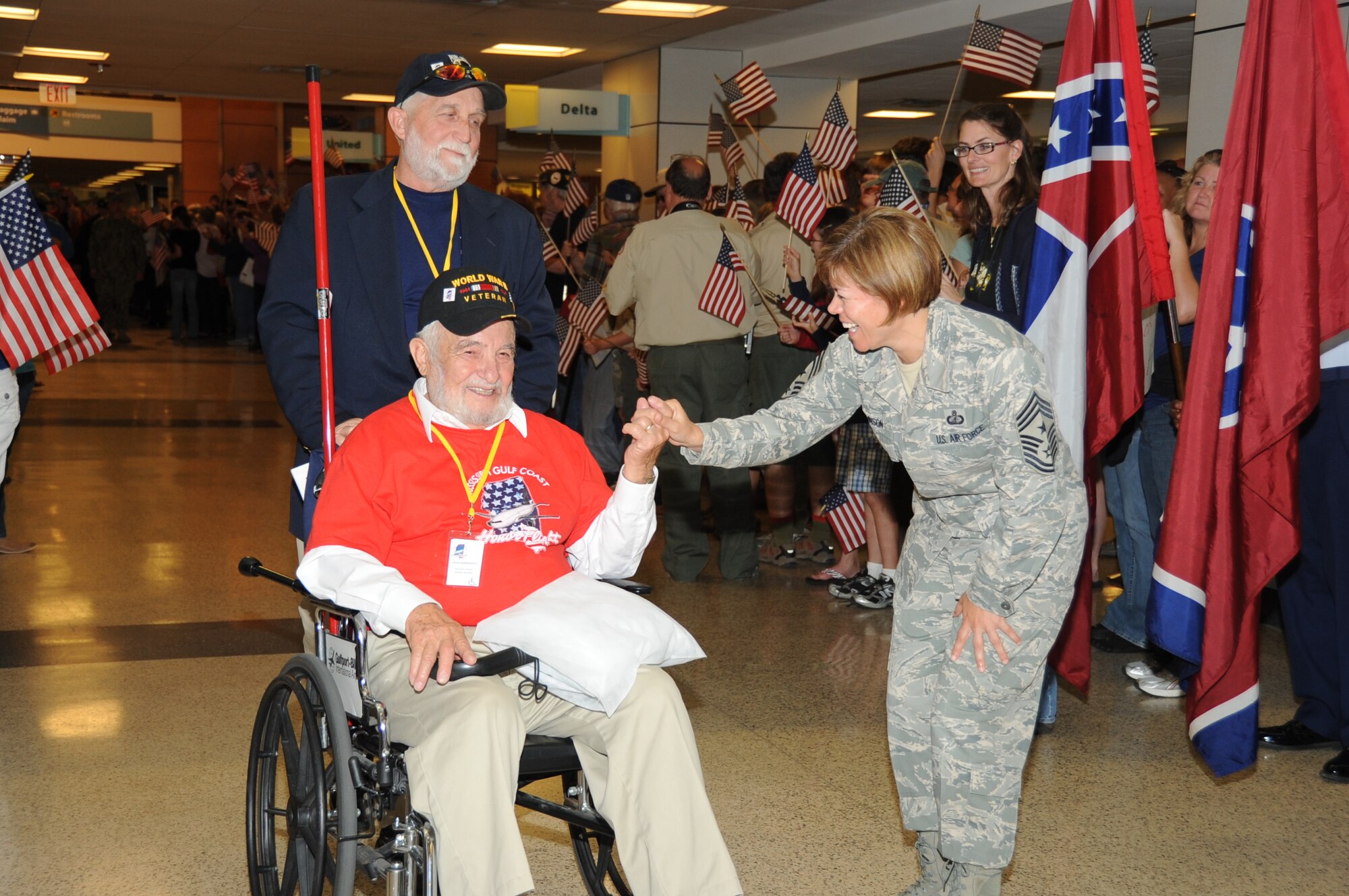 James Gautier escorts World War II Army veteran Julius Gainspoleti through a welcoming line as Chief Master Sgt. Angelica Johnson, 81st Training Wing command chief, Keesler Air Force Base, Miss., thanks him for his service upon returning from the third Mississippi Gulf Coast Honor Flight to Washington, D.C.,  April 24, 2012, at the Gulfport/Biloxi International Airport.  The Honor Flight program receives donations to honor our nation’s World War II veterans by sending them on a one-day visit to Arlington National Cemetery in Washington, D.C.   (U.S. Air Force photo by Kemberly Groue)