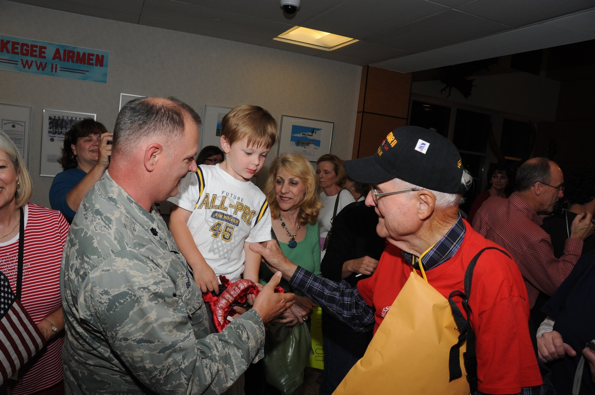 Lt. Col. Daniel Bessmer, 81st  Diagnostic and Therapeutics Squadron, and his son, Trevor, 4, welcome back World War II Army veteran James Drummond from the third Mississippi Gulf Coast Honor Flight to Washington, D.C.,  April 24, 2012, at the Gulfport/Biloxi International Airport.  The Honor Flight program receives donations to honor our nation’s World War II veterans by sending them on a one-day visit to Arlington National Cemetery in Washington, D.C.   (U.S. Air Force photo by Kemberly Groue)