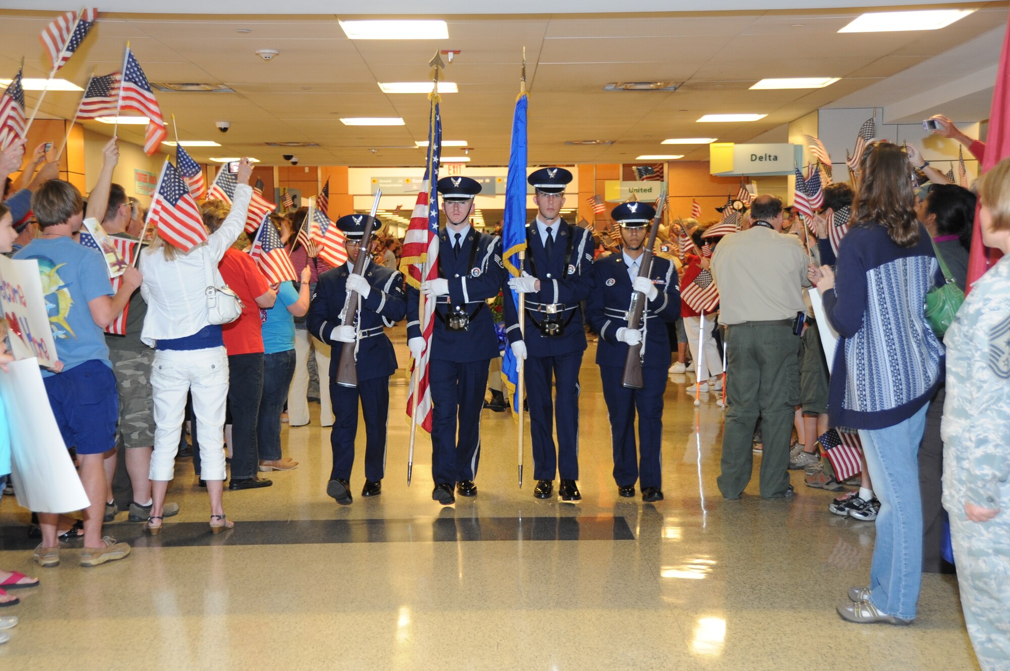 Members of the Keesler Honor Guard lead World War II veterans and their escorts through a welcoming line after the veterans returned from the third Mississippi Gulf Coast Honor Flight to Washington, D.C.,  April 24, 2012, at the Gulfport/Biloxi International Airport.  The Honor Flight program receives donations to honor our nation’s World War II veterans by sending them on a one-day visit to Arlington National Cemetery in Washington, D.C.   (U.S. Air Force photo by Kemberly Groue)
