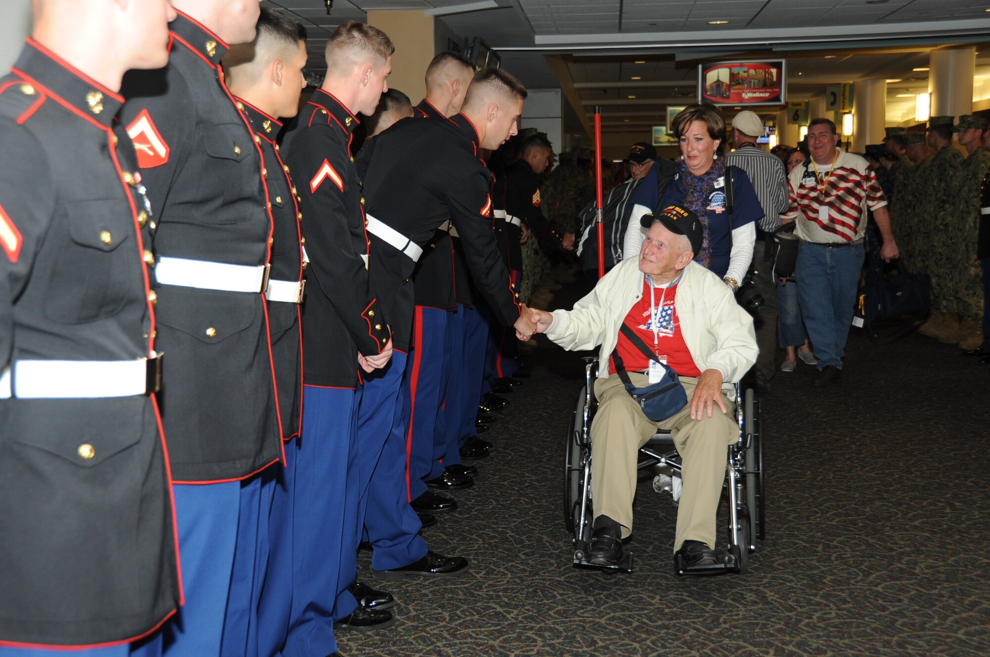 Lance Corporal Martin Douglas, Keesler Marine Detachment, welcomes back World War II Army veteran Owen Waters following his return from the third Mississippi Gulf Coast Honor Flight to Washington, D.C.,  April 24, 2012, at the Gulfport/Biloxi International Airport.  The Honor Flight program receives donations to honor our nation’s World War II veterans by sending them on a one-day visit to Arlington National Cemetery in Washington, D.C.  (U.S. Air Force photo by Kemberly Groue)
