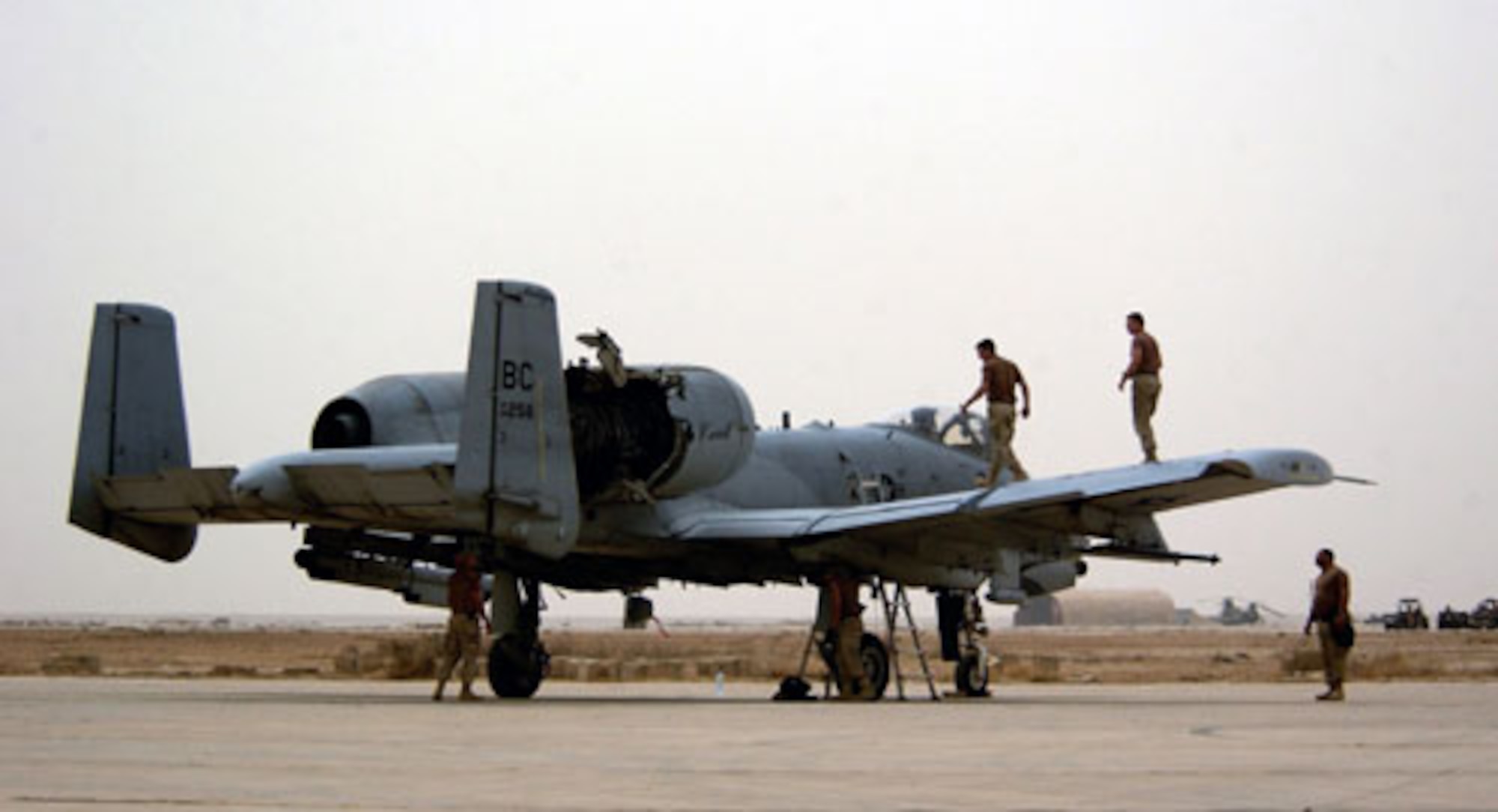 OPERATION IRAQI FREEDOM -- A-10 maintenance members from the 392 Air Expeditionary Wing inspect their aircraft for any additional damages after it was hit by an Iraqi missile in the right engine. The A-10 made it back to the base safely. (U. S. Air Force photo/Staff Sgt. Shane A. Cuomo)