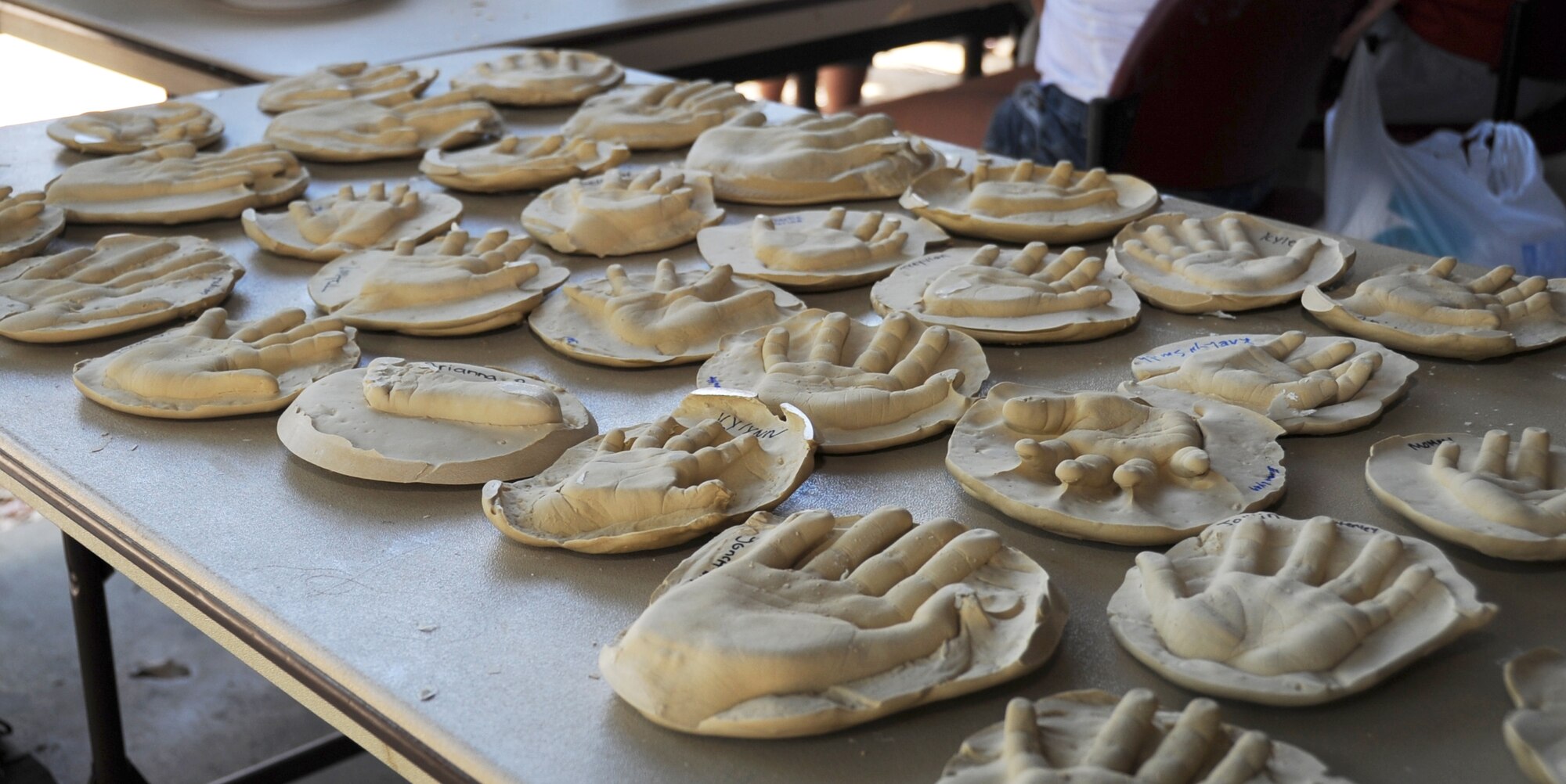 Impressions of children’s hands, sponsored by the 81st Dental Squadron, sit on display while they dry at Child Pride Day April 28, 2012, at Marina Park, Keesler Air Force Base, Miss.  Child Pride Day is an annual event held in conjunction with the month of the military child.  Booths, jumpers, activities, entertainment and food were set up throughout the park.  (U.S. Air Force photo by Kemberly Groue)