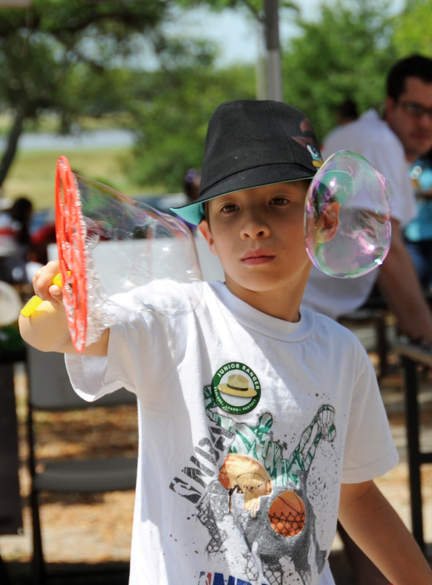 Ten-year-old Roberto Kerezsi, son of Yamilet and Tech. Sgt. Robert Kerezsi, 338th Training Squadron, makes bubbles during Child Pride Day April 28, 2012, at Marina Park, Keesler Air Force Base, Miss.  Child Pride Day is an annual event in collaboration with the month of the military child.  Booths, jumpers, activities, entertainment and food were set up throughout the park.  (U.S. Air Force photo by Kemberly Groue)