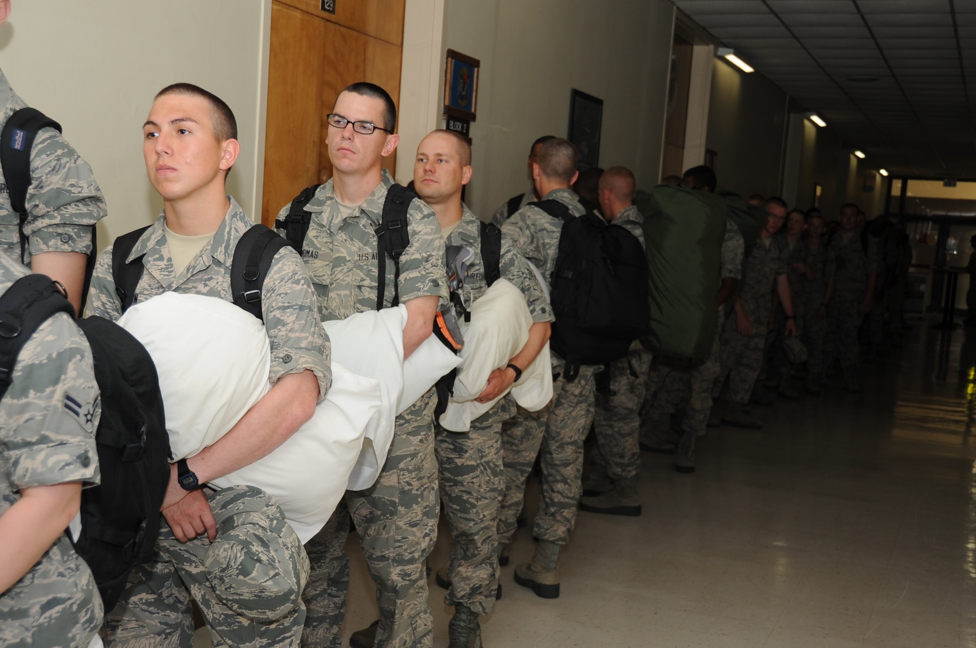 Airmen Basic Trey Show and Jonathan Thomas and Airman First Class Justin Smith, 338th Training Squadron, wait in line at Jones Hall to inprocess into the shelter during a Hurricane Condition Exercise April 27, 2012, at Keesler Air Force Base, Miss. The exercise was held from April 23-27 in preparation for hurricane season which runs from June 1 thru Nov. 30.  (U.S. Air Force photo by Kemberly Groue)