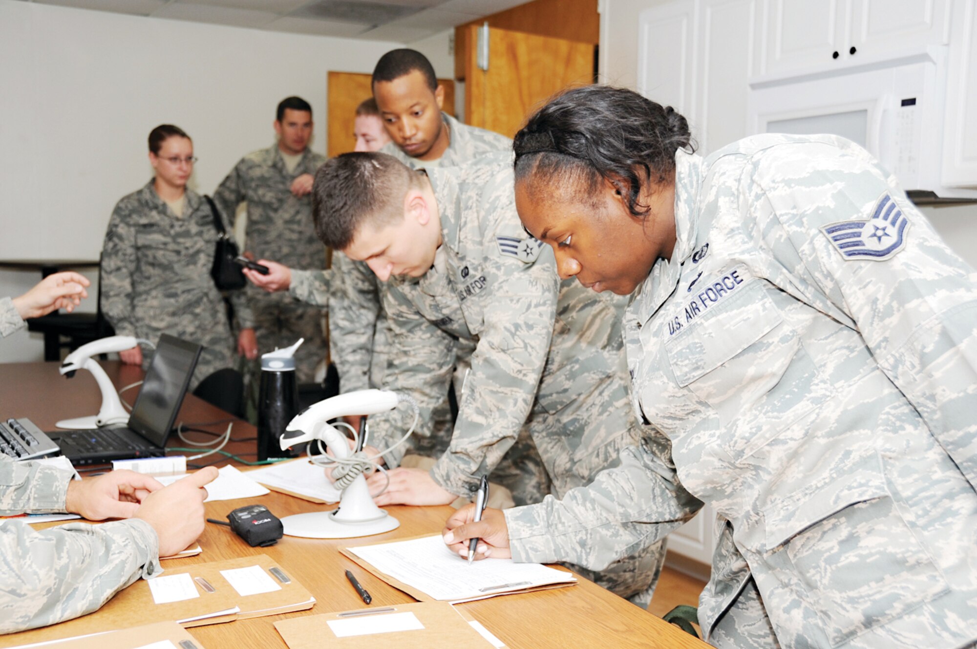 Staff Sgt. Jamal Kareem, Senior Airman Ryan Zaremba and Staff Sgt. Kirshell LaCroix, 81st Contracting Squadron, inprocess at Jones Hall to shelter during a Hurricane Condition Exercise April 27, 2012, at Keesler Air Force Base, Miss. The exercise was held from April 23-27 in preparation for hurricane season which runs from June 1 thru Nov. 30.  (U.S. Air Force photo by Kemberly Groue)