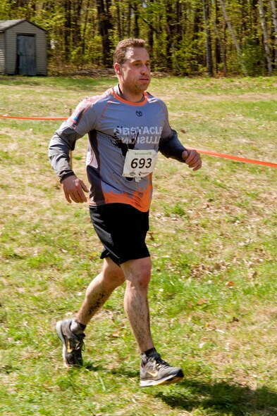 MANCHESTER, N.H. -- Capt. Andy Smith runs from one obstacle to another during the Adventure 5k at McIntyre Ski area April 28. Smith and ten others from the New Hampshire Air National Guard participated as a team called Obstacle Illusion. More than 800 participants ran through mud trails and over obstacles during the 3.1 mile event. (National Guard photo by Tech. Sgt. Mark Wyatt/Released)