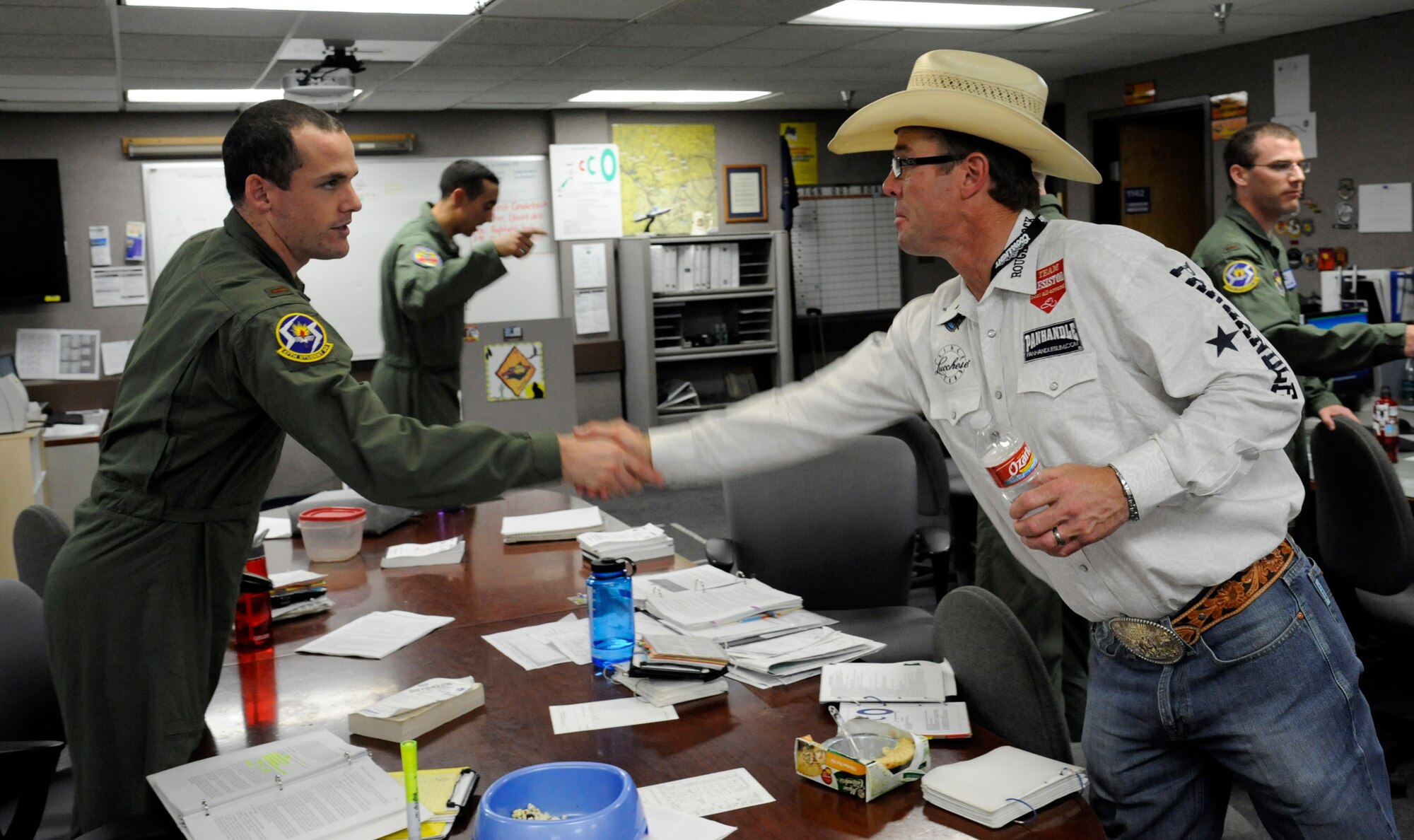Richard “Tuff” Hedeman, a three-time World Champion bull rider, greets a student pilot at Anderson Hall during a tour of Laughlin Air Force Base, Texas, April 27, 2012. The tour offered the six professional bull riders a firsthand look at the 47th Flying Training Wing’s mission of training world class pilots, deploying mission-ready Airmen and developing professional, disciplined leaders. (U.S. Air Force photo/Airman 1st Class Nathan Maysonet) 