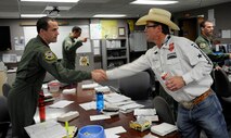 Richard “Tuff” Hedeman, a three-time World Champion bull rider, greets a student pilot at Anderson Hall during a tour of Laughlin Air Force Base, Texas, April 27, 2012. The tour offered the six professional bull riders a firsthand look at the 47th Flying Training Wing’s mission of training world class pilots, deploying mission-ready Airmen and developing professional, disciplined leaders. (U.S. Air Force photo/Airman 1st Class Nathan Maysonet) 