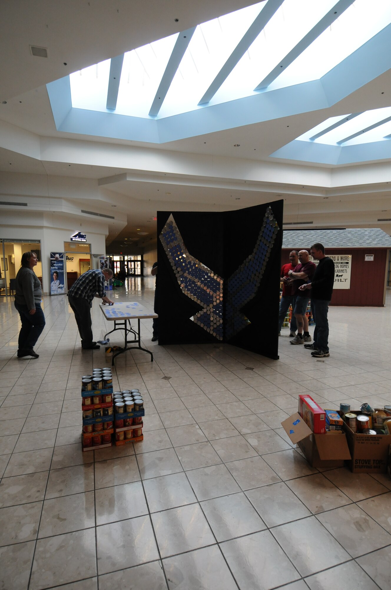 Servicemembers from the 110th Airlift Wing, Battle Creek Air National Guard Base and their families participate in the local food drive Canned Sculpture Exhibit held at Lakeview Square Mall, Battle Creek, Mich., on Sunday, April 22, 2012. A donation of over $600 was collected toward the sculpture equaling over a 1,000 cans. All food collected is donated to the Food Bank of South Central Michigan. Sculptures will be on display until Sunday, May 6, 2012. (U.S. Air National Guard Photo by Master Sgt. Sonia Pawloski/Released)