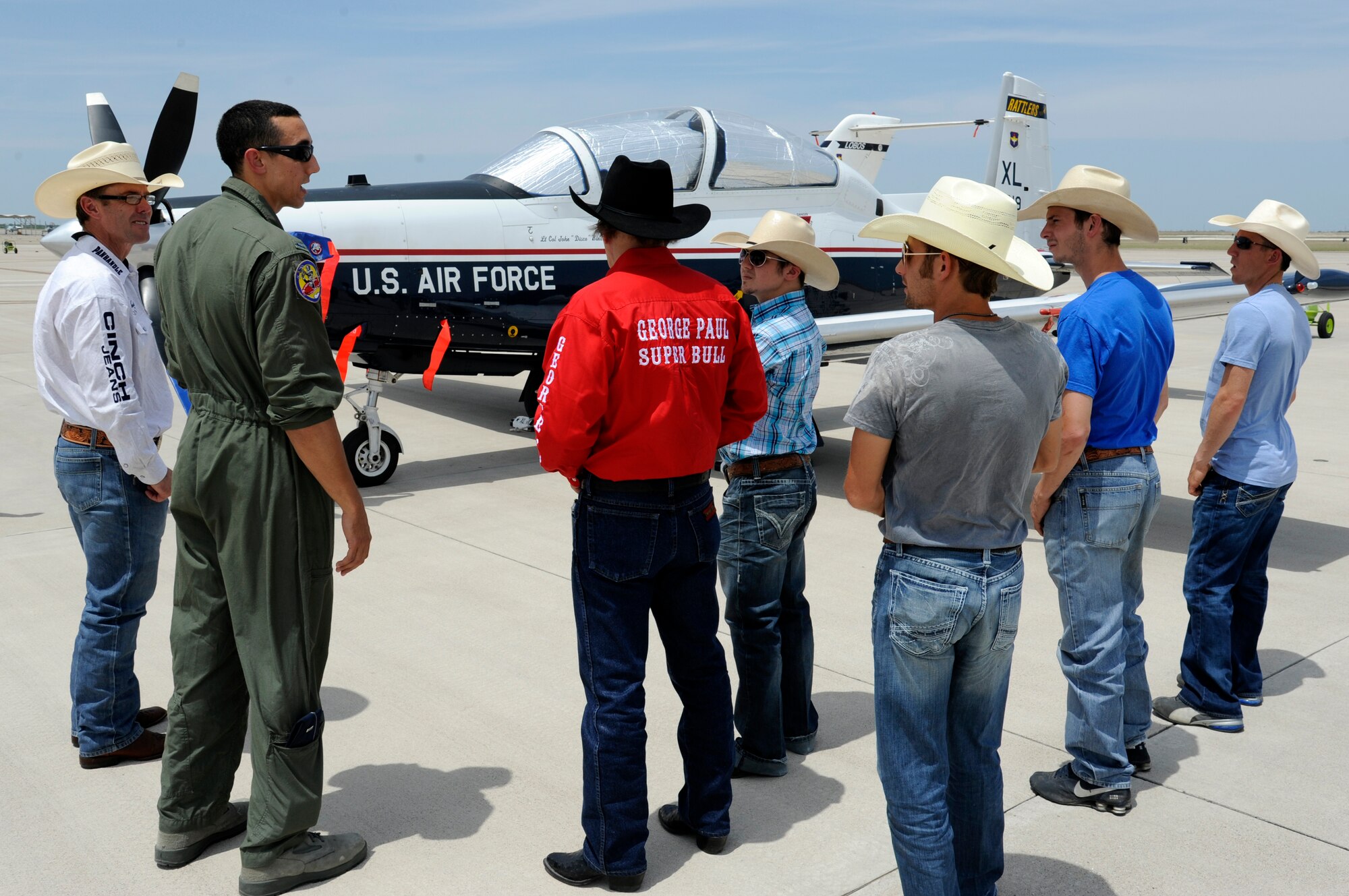 A group of professional bull riders listen to 1st Lt. Taylor Wight, 85th Flying Training Squadron instructor pilot, describe the T-6A Texan II aircraft during a tour of the flight line at Laughlin Air Force Base, Texas, April 27, 2012. The tour offered the six professional bull riders a firsthand look at the 47th Flying Training Wing’s mission of training world class pilots, deploying mission-ready Airmen and developing professional, disciplined leaders. (U.S. Air Force photo/Airman 1st Class Nathan Maysonet) 