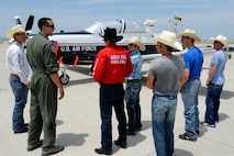 A group of professional bull riders listen to 1st Lt. Taylor Wight, 85th Flying Training Squadron instructor pilot, describe the T-6A Texan II aircraft during a tour of the flight line at Laughlin Air Force Base, Texas, April 27, 2012. The tour offered the six professional bull riders a firsthand look at the 47th Flying Training Wing’s mission of training world class pilots, deploying mission-ready Airmen and developing professional, disciplined leaders. (U.S. Air Force photo/Airman 1st Class Nathan Maysonet) 
