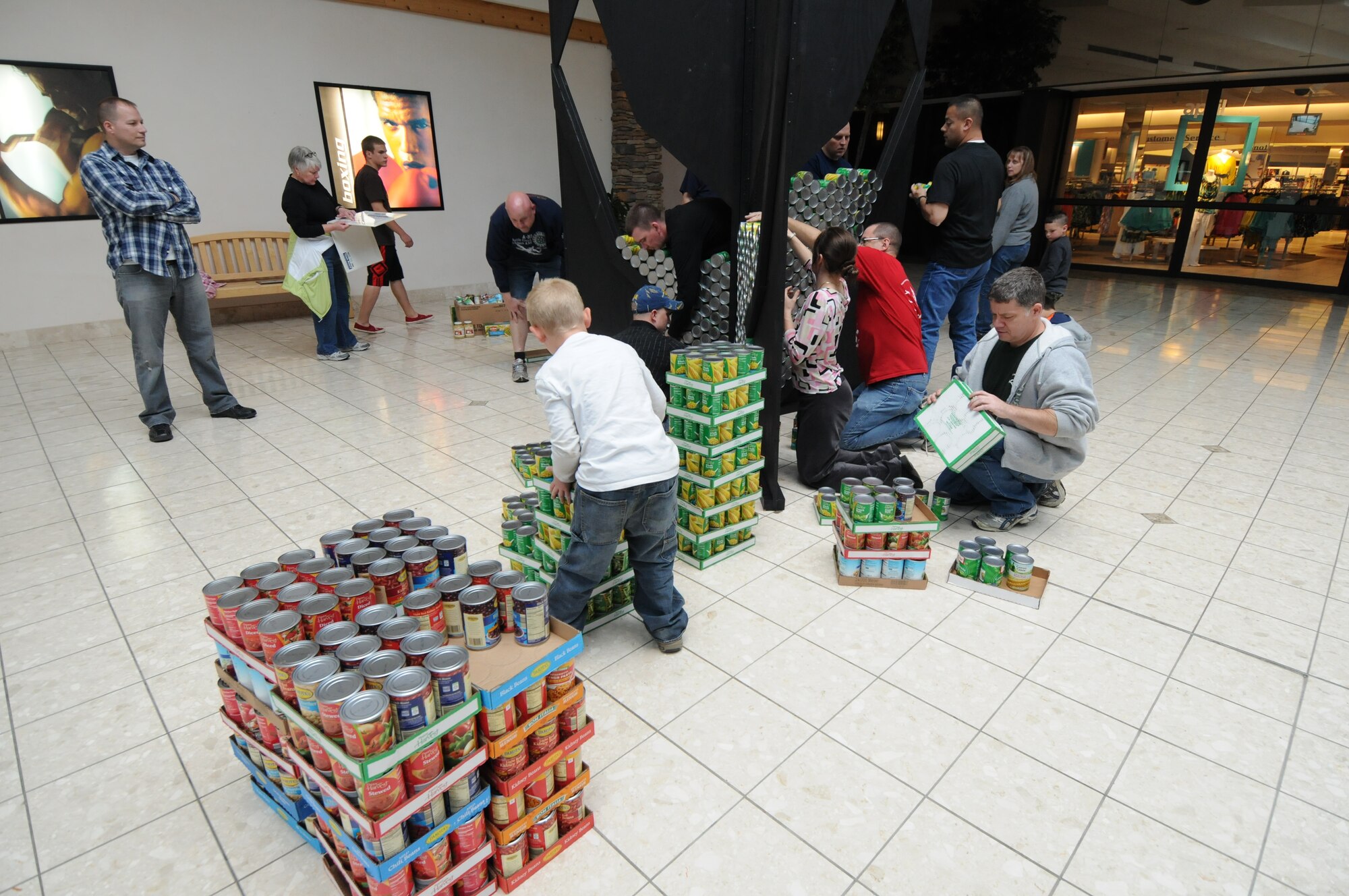 Servicemembers from the 110th Airlift Wing, Battle Creek Air National Guard Base and their families participate in the local food drive Canned Sculpture Exhibit held at Lakeview Square Mall, Battle Creek, Mich., on Sunday, April 22, 2012. A donation of over $600 was collected toward the sculpture equaling over a 1,000 cans. All food collected is donated to the Food Bank of South Central Michigan. Sculptures will be on display until Sunday, May 6, 2012. (U.S. Air National Guard Photo by Master Sgt. Sonia Pawloski/Released)