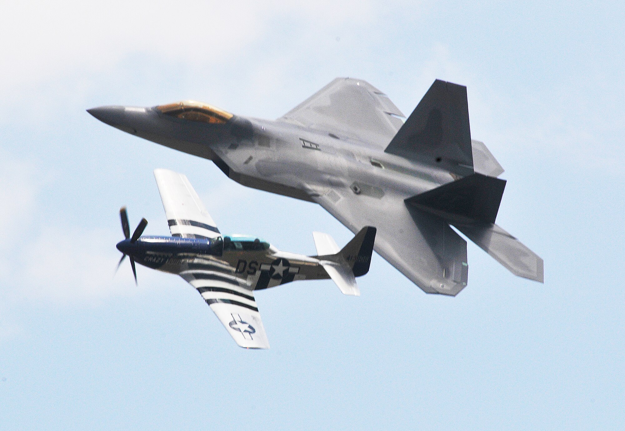 A heritage flight during the Robins Air Show 2012 featured an F-22 Raptor and  a P-51 Mustang.  (U. S. Air Force photo by Sue Sapp)