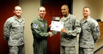 Staff Sgt. Darrius Tyler, 47th Flying Training Wing Command Post NCO in charge of console operations, poses with Col. Tom Murphy, 47th FTW commander, and Chief Master Sgt. Ray DeVite, 47th FTW command chief, after being presented the XLer of the week award at Laughlin Air Force Base, Texas, April 25, 2012. The XLer is a weekly award chosen by wing leadership and given to those who consistently make outstanding contributions to Laughlin and their unit. (U.S. Air Force photo/Airman 1st Class Nathan Maysonet)
