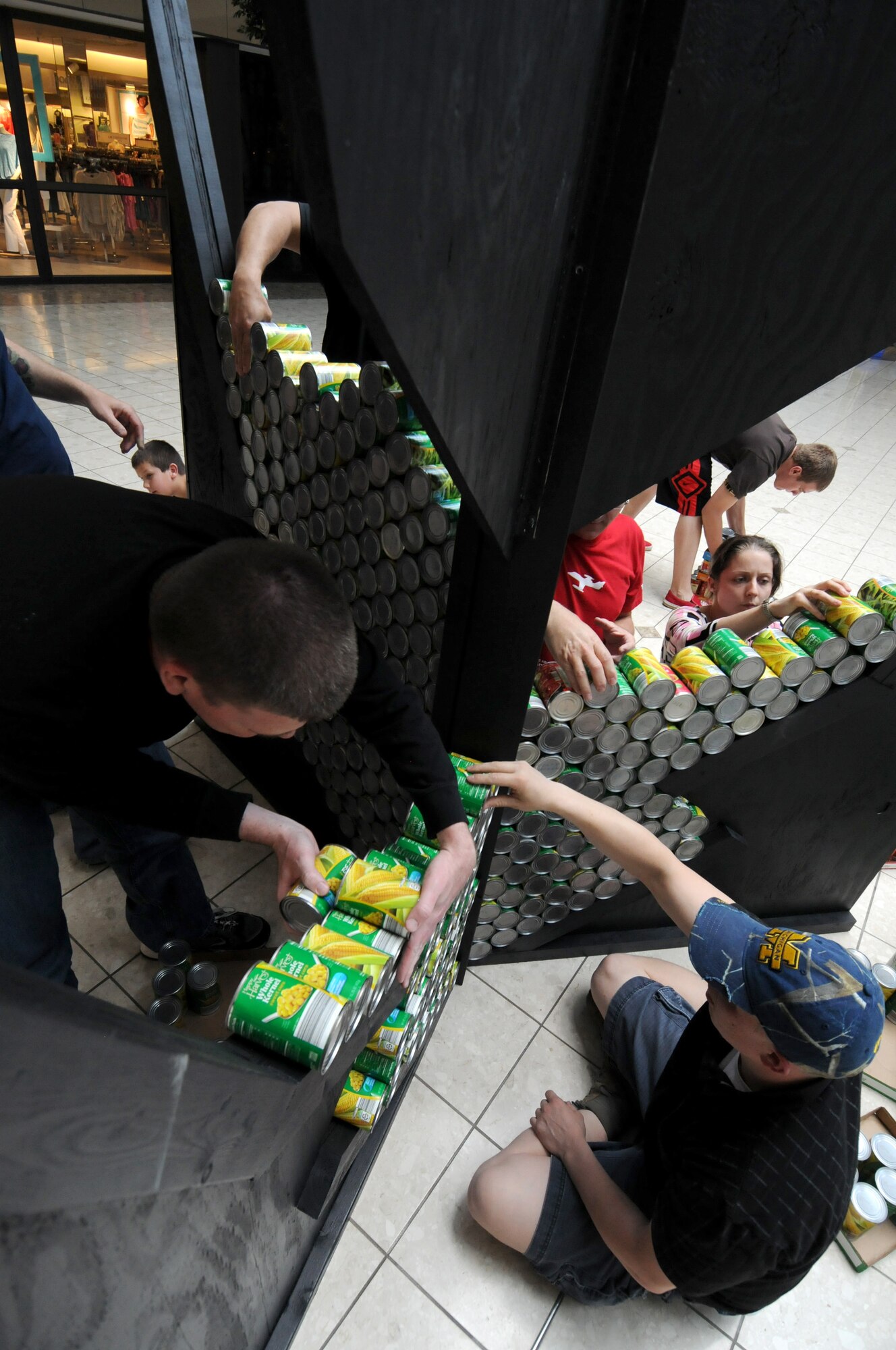Servicemembers from the 110th Airlift Wing, Battle Creek Air National Guard Base and their families participate in the local food drive Canned Sculpture Exhibit held at Lakeview Square Mall, Battle Creek, Mich., on Sunday, April 22, 2012. A donation of over $600 was collected toward the sculpture equaling over a 1,000 cans. All food collected is donated to the Food Bank of South Central Michigan. Sculptures will be on display until Sunday, May 6, 2012. (U.S. Air National Guard Photo by Master Sgt. Sonia Pawloski/Released)