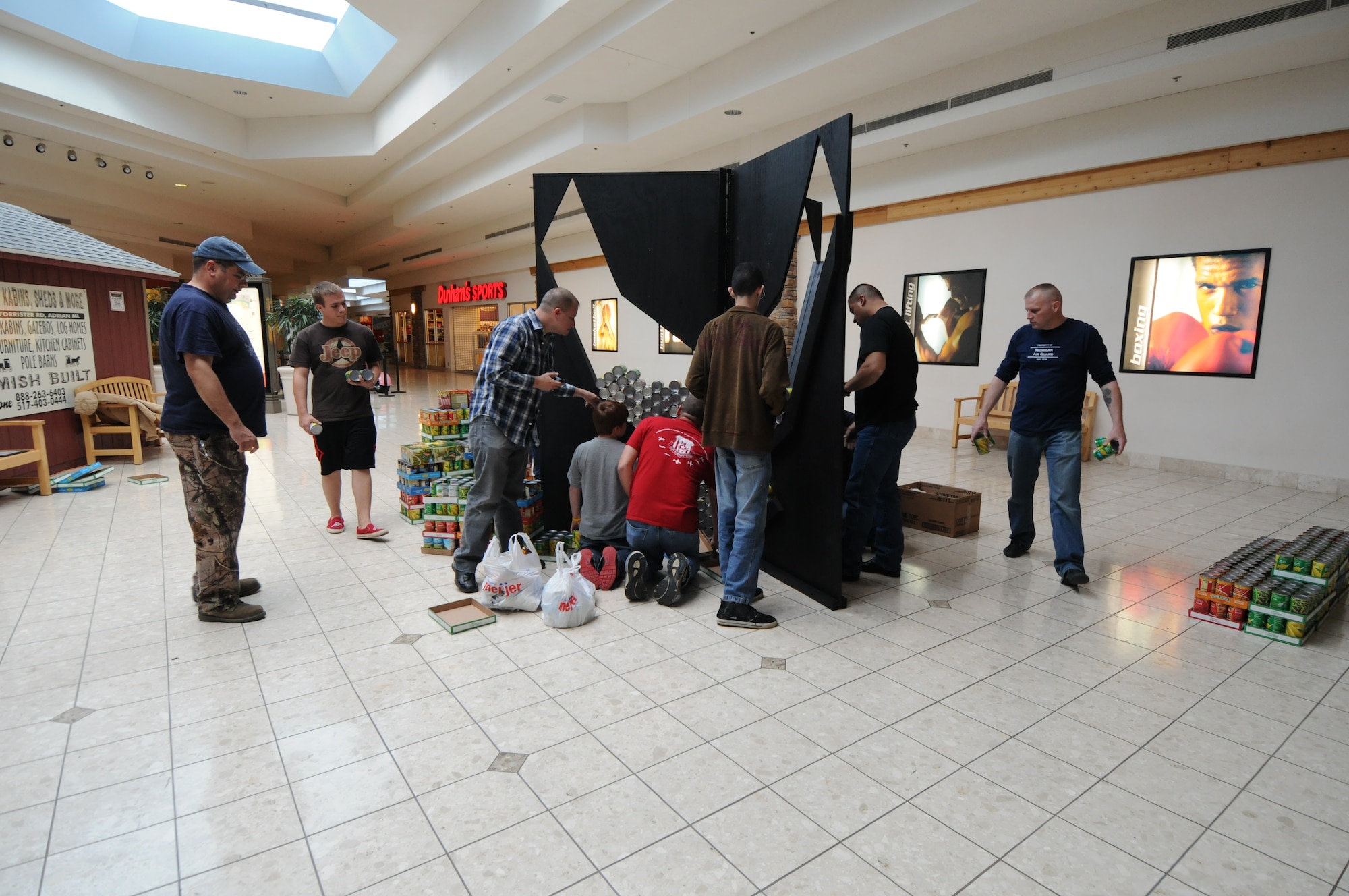 Servicemembers from the 110th Airlift Wing, Battle Creek Air National Guard Base and their families participate in the local food drive Canned Sculpture Exhibit held at Lakeview Square Mall, Battle Creek, Mich., on Sunday, April 22, 2012. A donation of over $600 was collected toward the sculpture equaling over a 1,000 cans. All food collected is donated to the Food Bank of South Central Michigan. Sculptures will be on display until Sunday, May 6, 2012. (U.S. Air National Guard Photo by Master Sgt. Sonia Pawloski/Released)