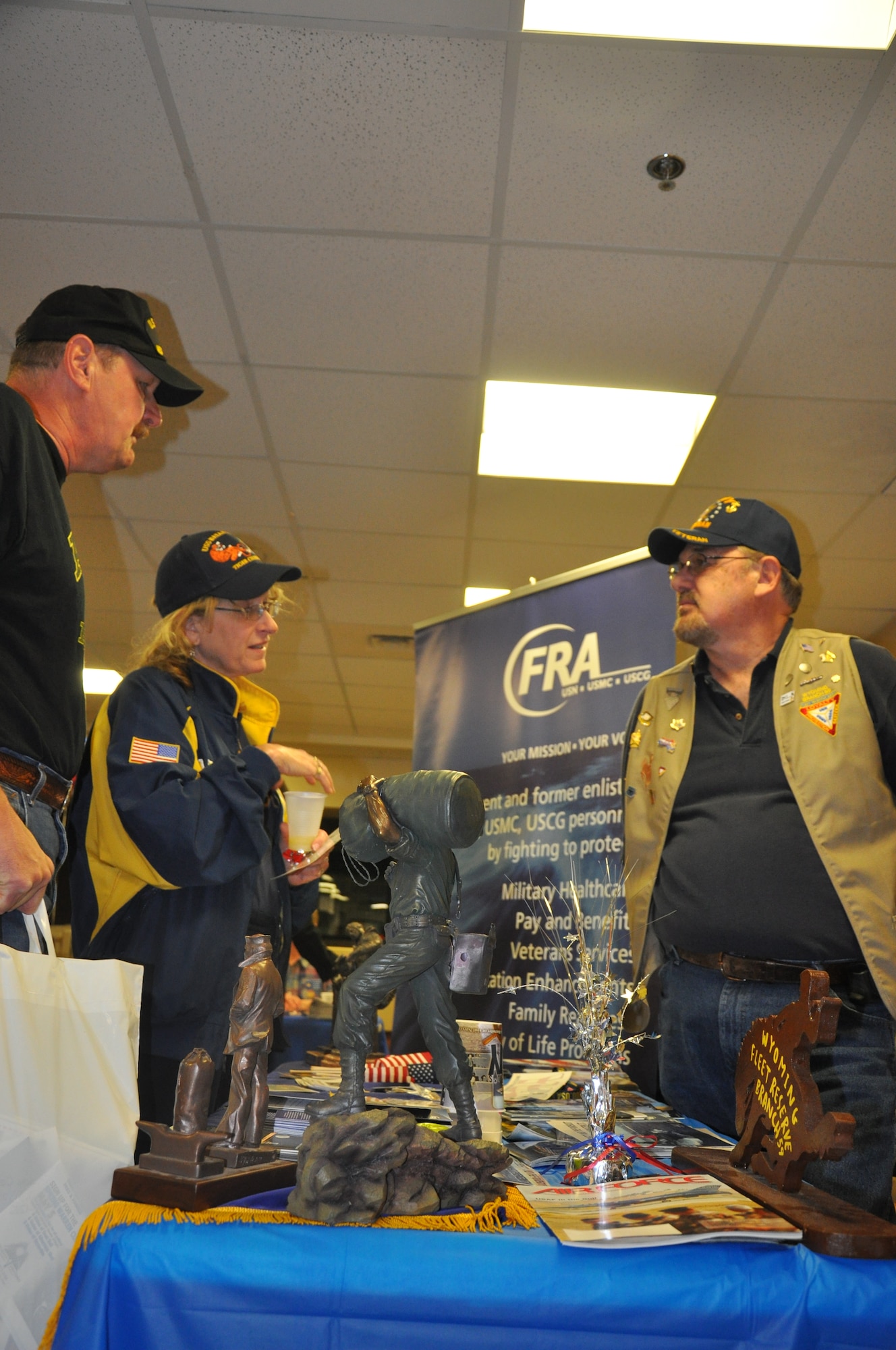 Dick Clowdus, Fleet Reserve Association Branch 59 representative, discusses what his organization has to offer with members of the local retired military community at the Fleet Reserve Association’s booth April 21 during Warren’s Retiree Appreciation Day event in the 90th Medical Group clinic. (U.S. Air Force photo by Airman 1st Class Dan Gage)