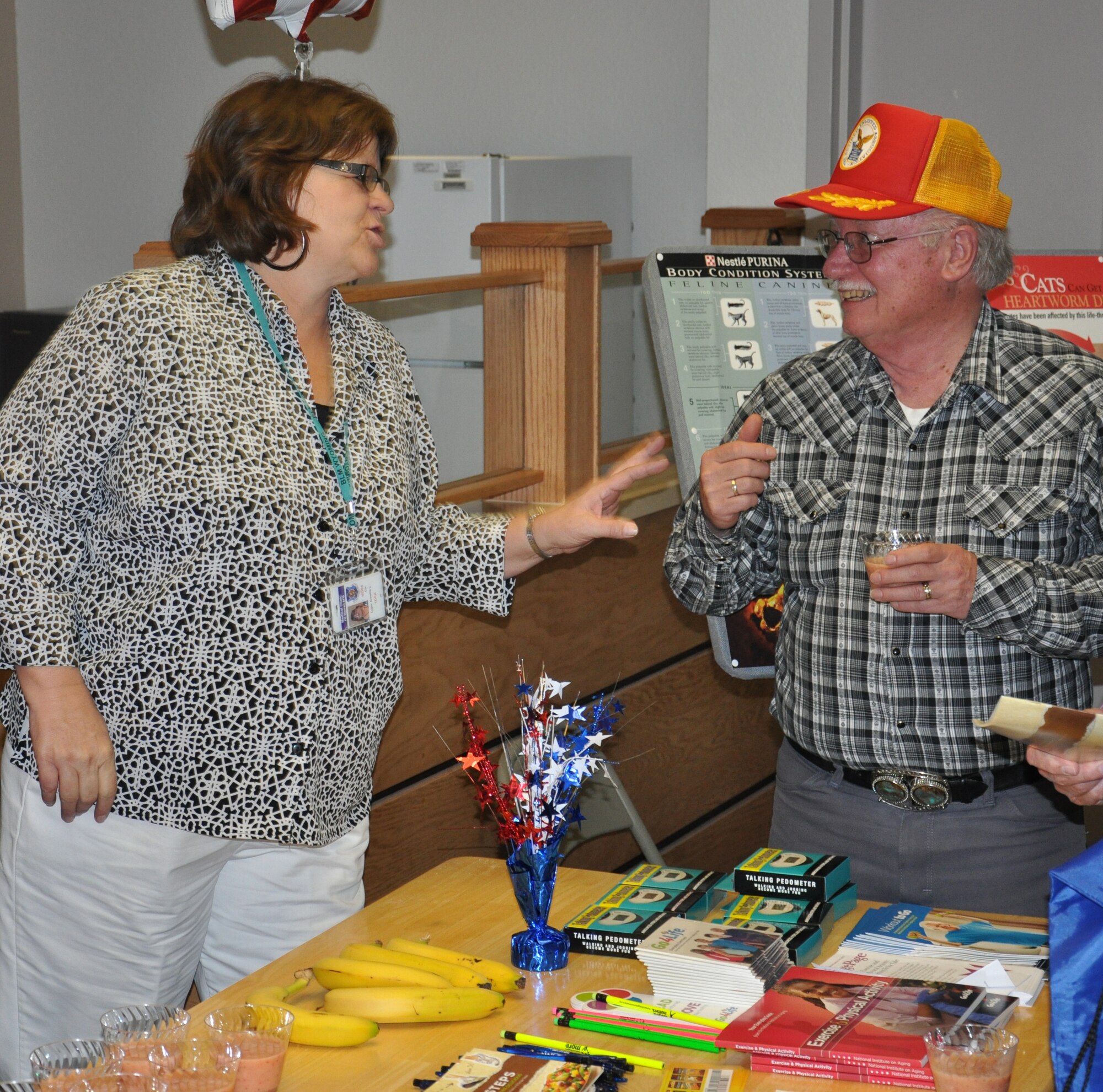 Annette Lupo, 90th Medical Support Squadron, shares a laugh and a smoothie with a retiree during Warren’s Retiree Appreciation Day event held in the 90th Medical Group clinic April 21. (U.S. Air Force photo by Airman 1st Class Dan Gage)