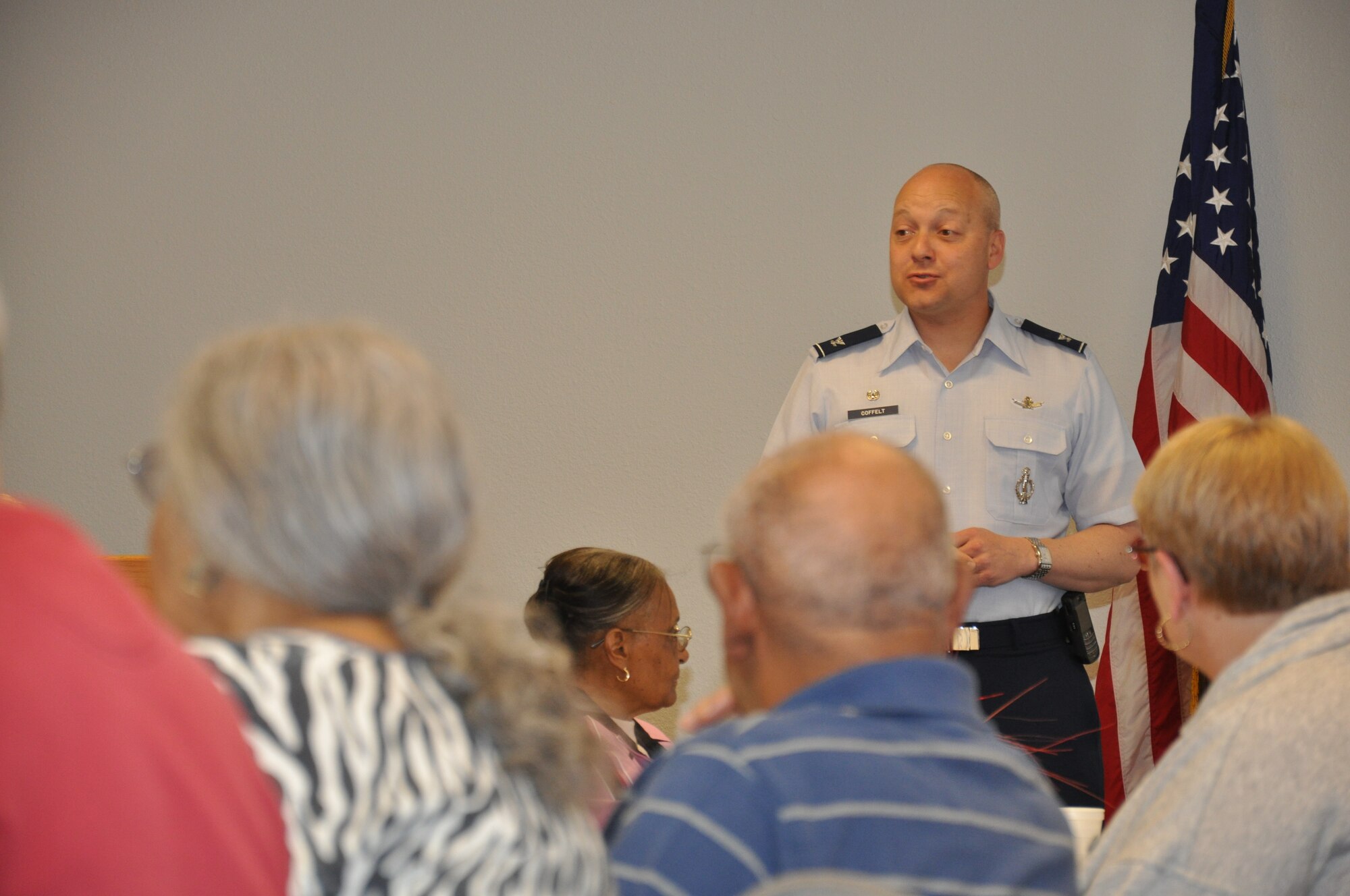 Col. Christopher Coffelt, 90th Missile Wing commander, welcomes retirees from the local area to Warren’s Retiree Appreciation Day held in the 90th Medical Group clinic April 21. Coffelt took the opportunity to discuss recent changes effecting retired members and responded to questions that were asked by individuals. (U.S. Air Force photo by Airman 1st Class Dan Gage)