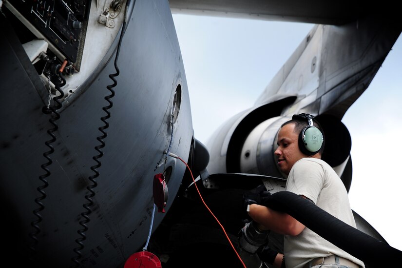 Senior Airman Rafael Lopez-Martinez moves the hose into place before refueling a C-17 Globemaster III, at Joint Base Charleston - Air base, April 18. The C-17 can hold up to 35,546 gallons of fuel and can carry a maximum of 17,900 pounds and land on runways as short as 3,500 feet which is crucial to resupplying remote areas from the air or ground. Lopez-Martinez is from the 437 Aircraft Maintenance Squadron Gold AMU.  (U.S. Air Force photo/ Staff Sgt. Nicole Mickle)  