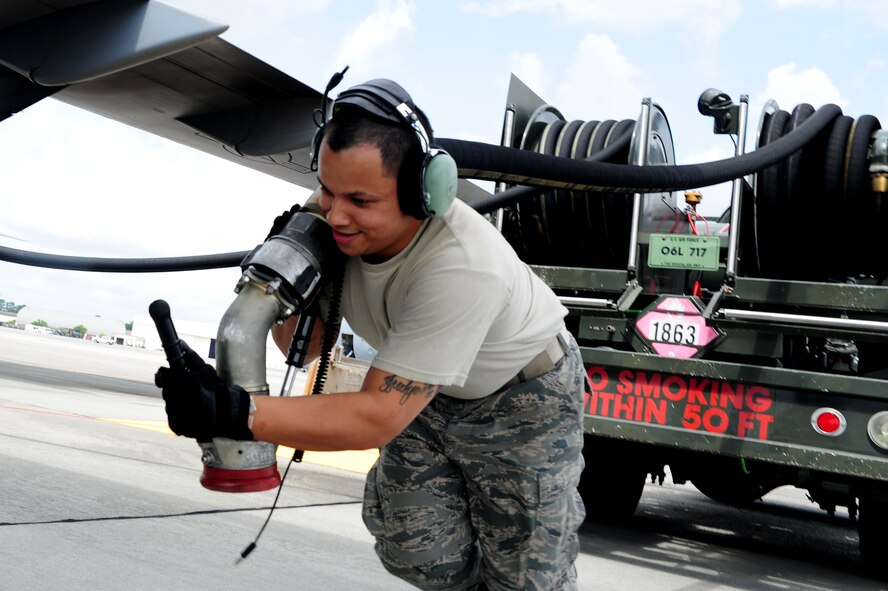 Senior Airman Rafael Lopez-Martinez pulls the hose towards a C-17 Globemaster III before refueling, at Joint Base Charleston, S.C., April 18, 2012. The C-17 can hold up to 35,546 gallons of fuel and can carry a maximum of 17,900 pounds and land on runways as short as 3,500 feet which is crucial to resupplying remote areas from the air or ground. Lopez-Martinez is from the 437 Aircraft Maintenance Squadron Gold AMU. (U.S. Air Force photo/Staff Sgt. Nicole Mickle)