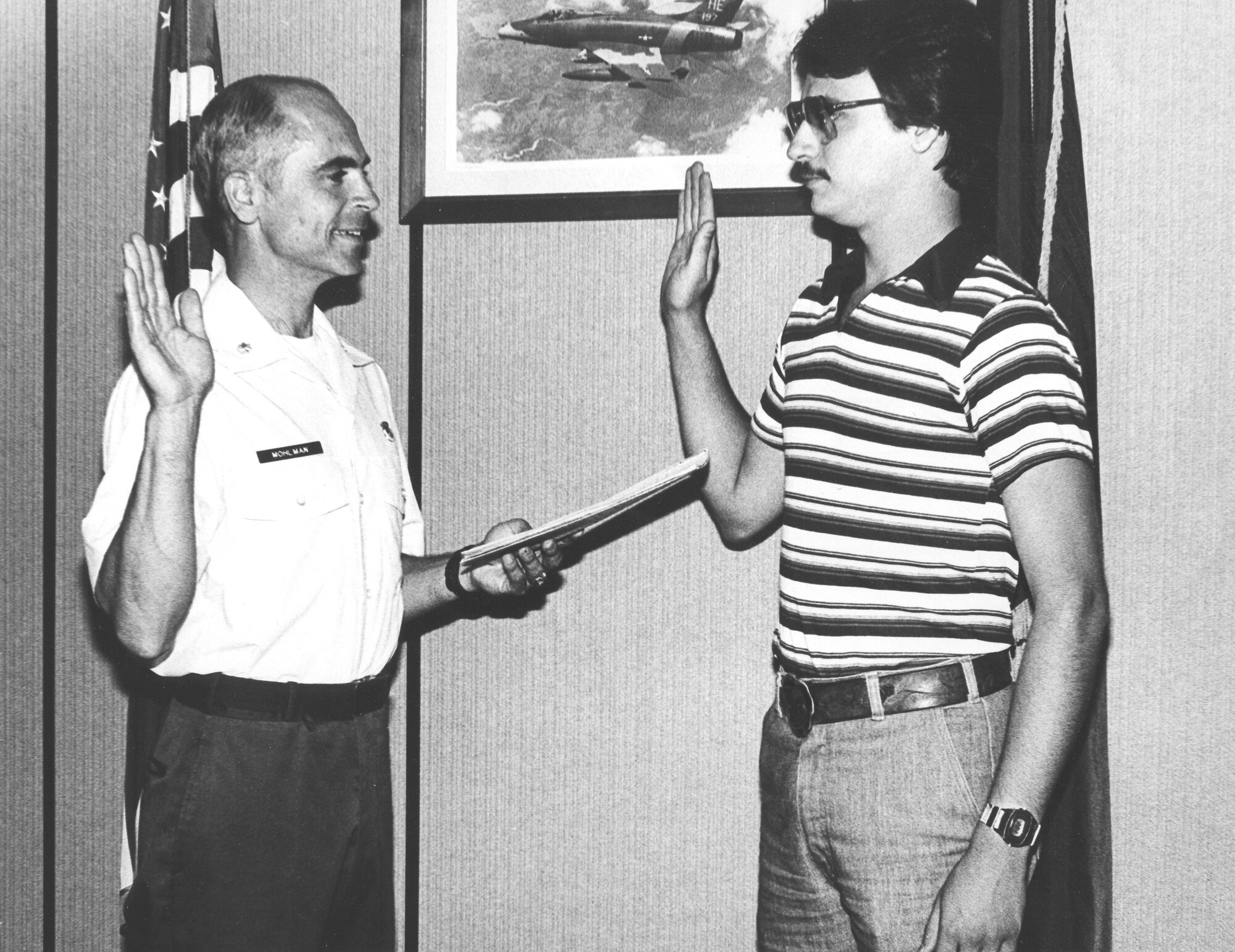 Master Sgt. Brian Mohlman makes his first oath of enlistment on June 4, 1979 at the Battle Creek Air National Guard Base, Mich. Master Sgt. Mohlman is sworn in by Lt. Col. Harold Mohlman (retired), his father. (U. S. Air National Guard Photos courtesy of 110th Force Support Squadron Master Sgt. Brian Mohlman/Released)
