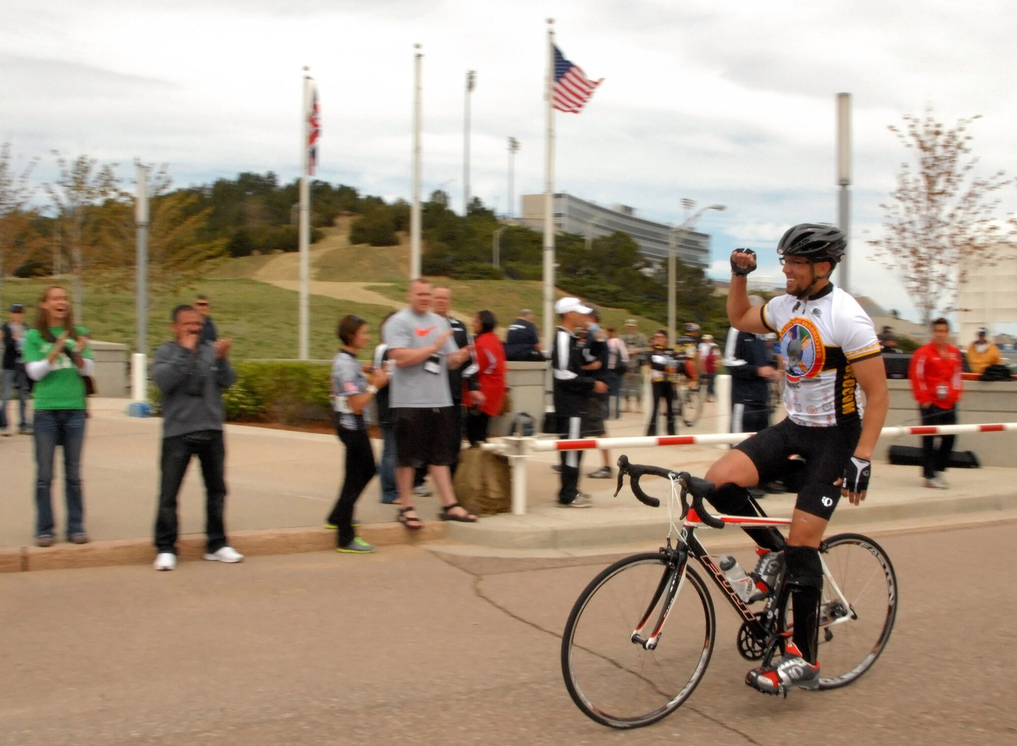 U.S. Air Force Staff Sgt. Johnnie Yellock, Air Force Special Operations Command combat controller, is cheered on by spectators and his family as he completes the men's bicycle open competition during the 2012 Warrior Games in Colorado Springs, Colo., May 1. The U.S. Special Operations Command team member is competing in four events during the week-long Warrior Games. 
