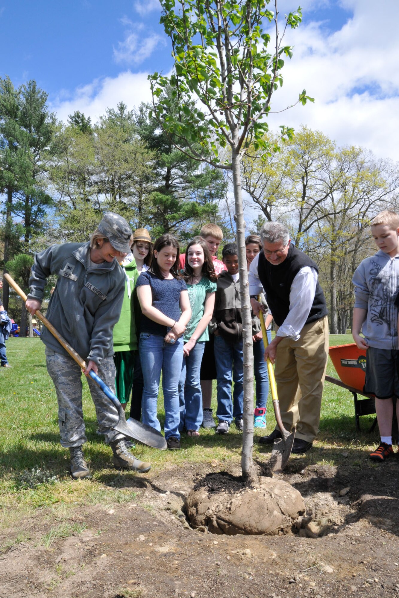 HANSCOM AIR FORCE BASE, Mass. – Col. Stacy L. Yike (left), 66th Air Base Group commander, Greg Cravedi, Civil Engineering Environmental office, and Hanscom Middle School students help plant a pear tree along Eglin Street near the clinic as part of Arbor Day activities April 27. The tree planting ceremony was just one of several efforts base personnel accomplished to achieve Tree City USA status for the 25th year in a row. (U.S. Air Force photo by Linda LaBonte Britt)
