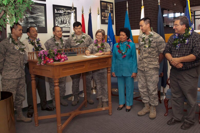 HANSCOM AIR FORCE BASE, Mass. – Members of the Asian Pacific American Heritage Month committee watch as Col. Stacy L. Yike (center), 66th Air Base Group commander, signs a proclamation declaring the month of May as APAHM at Hanscom. Committee members in attendance from left to right include 2nd Lt. David Lam, Don Seta, Capt. Paul Park, 2nd Lt. Samuel Han, Angie Fedukowski, 1st Lt Joel Mercado and Mark Newell. (U.S. Air Force photo by Walter Santos)
