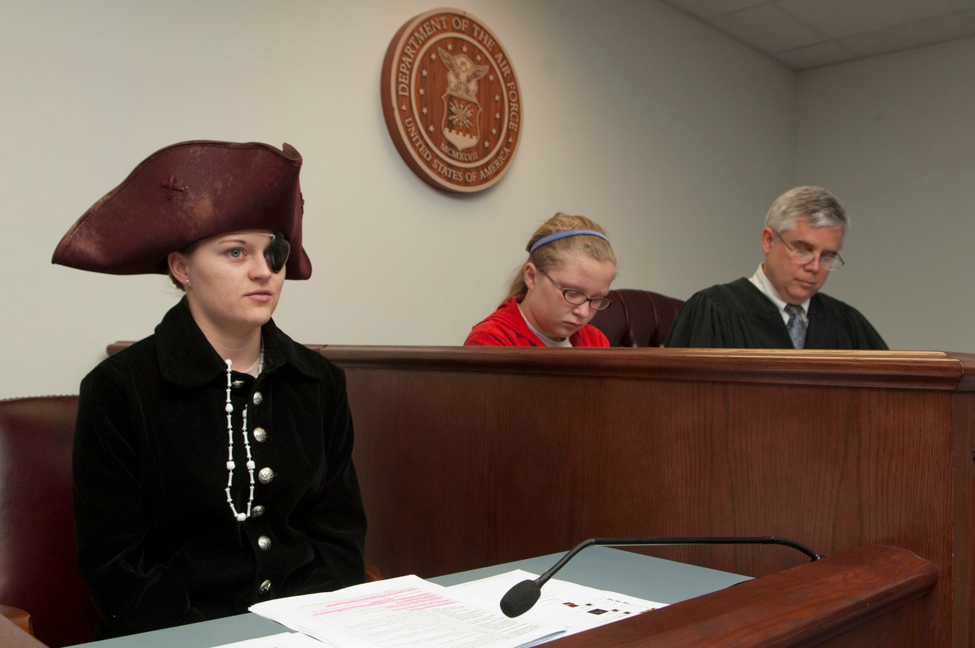 HANSCOM AIR FORCE BASE, Mass. – Senior Airman Stephanie Roberts, playing as Sallie Two-Guns, is questioned in the witness chair as Peter Babcock (right), Electronic Systems Center attorney, and student Phoebe DeLory act as judges during Law Day April 24. The ESC Legal office celebrated Law Day 2012 on April 24 with a pirate-themed mock trial for Hanscom Middle School students. (U.S. Air Force photo by Mark Wyatt)