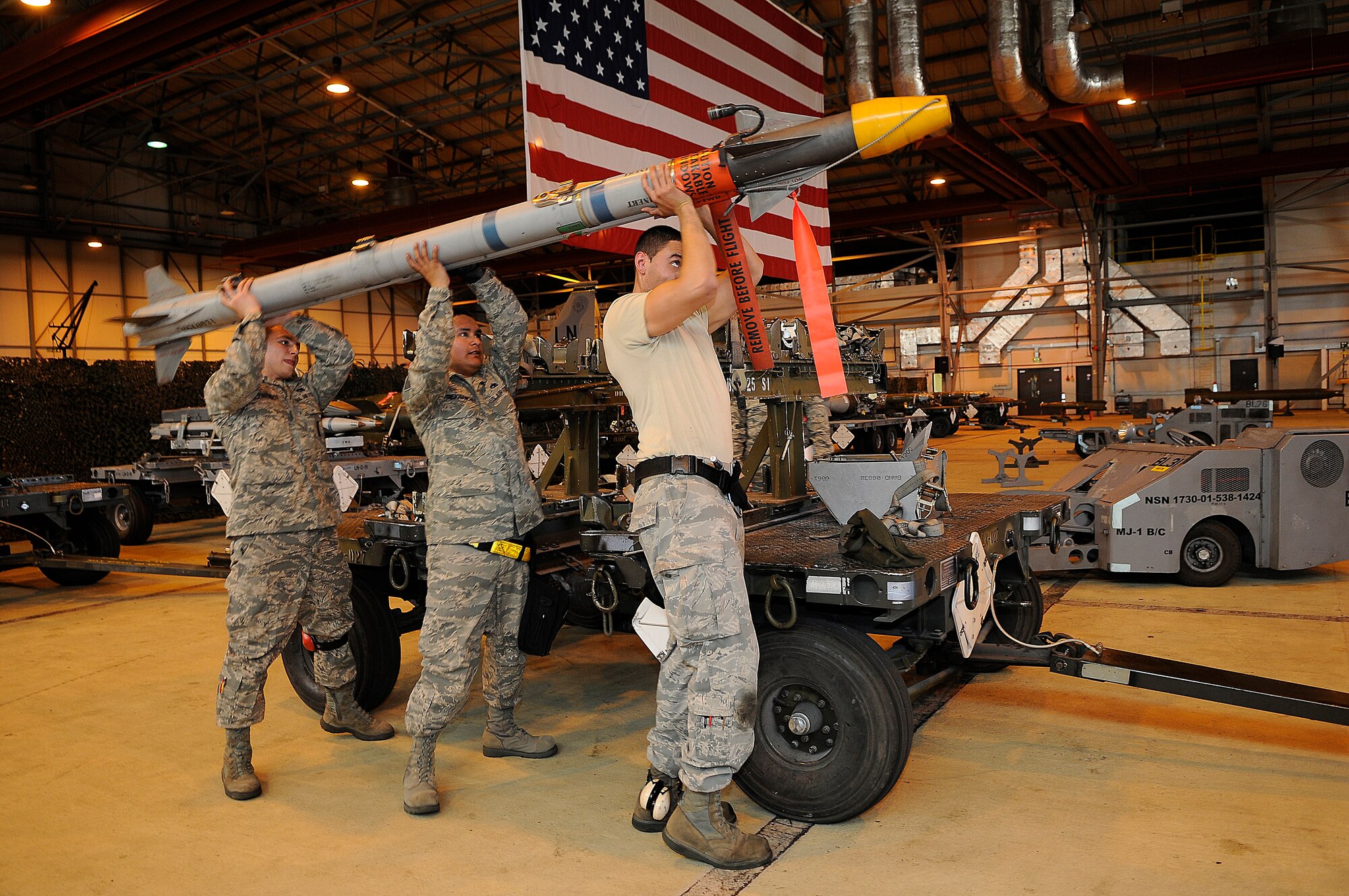 ROYAL AIR FORCE LAKENHEATH, England -- Weapons load crew team members from the 493rd Aircraft Maintenance Unit prepare to load an Air Intercept Missle 9x munition onto an F-15C Eagle during the quarterly Load Crew Competition April 20, 2012. The competition features the best load crew teams from the 492nd, 493rd and 494th AMUs. The winner is determined by the fastest time loading munitions with the least amount of errors. (U.S. Air Force photo by Staff Sgt. Connor Estes)