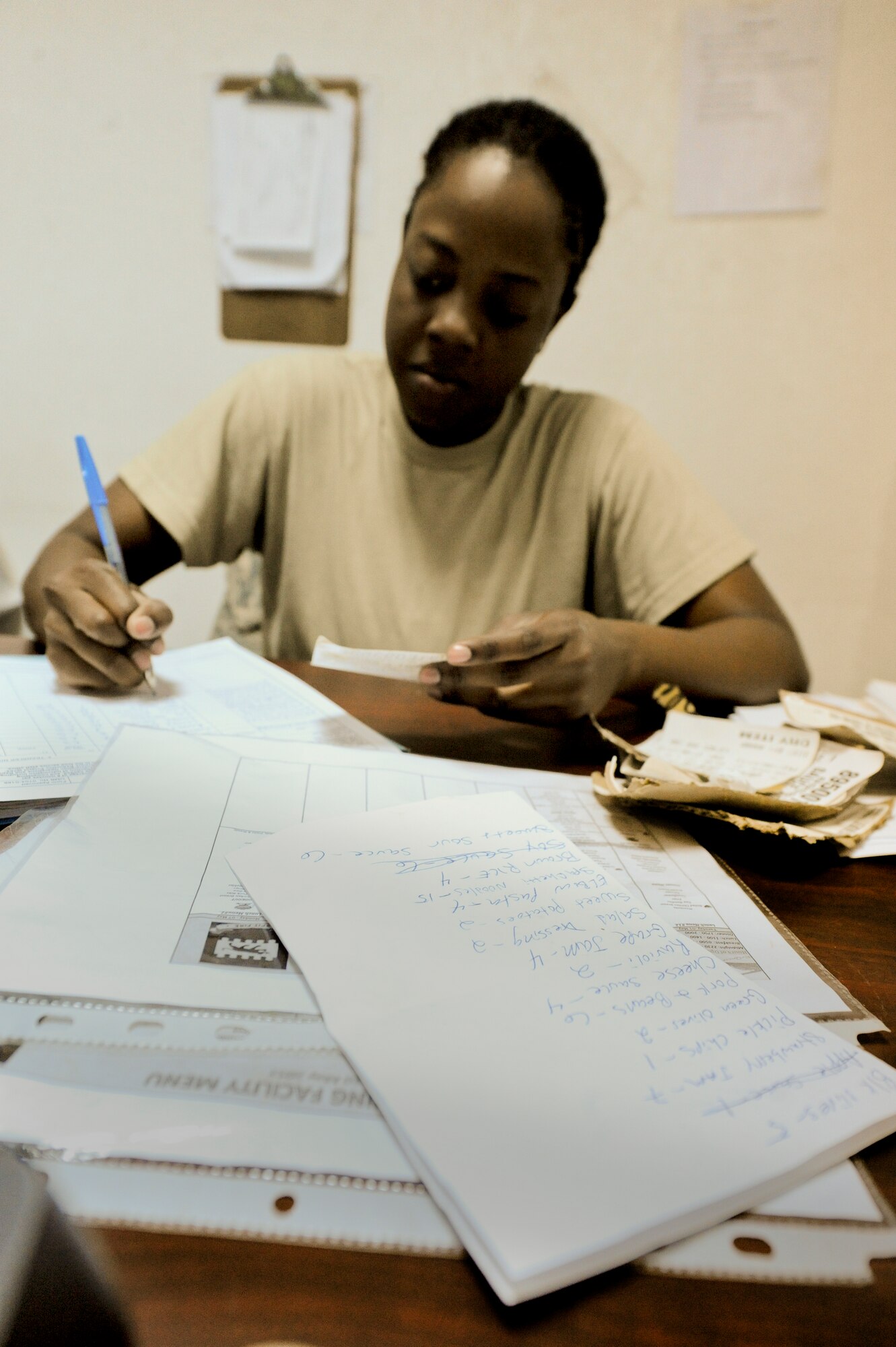 SOUTHWEST ASIA -- Senior Airman Vertalya Reddick, 332nd Expeditionary Force Support Squadron, goes over inventory paperwork here, May 1, 2012. Inventory is performed to see what items are in-stock at the dining facility. Reddick is deployed from Joint Base Langley-Eustis, Va., and is a native of Boston, Mass. (U.S. Air Force photo by Staff Sgt. Joshua J. Garcia)