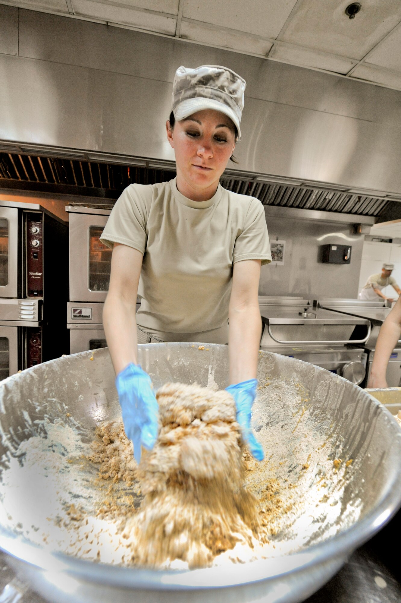 SOUTHWEST ASIA -- Staff Sgt. Abby Ford, 332nd Expeditionary Force Support Squadron, prepares chicken tenders for the lunch meal here, May 1, 2012. The chicken tenders were made with a home-made recipe. Ford is deployed with the Nebraska Air National Guard, and is a native of Lewellen, Neb. (U.S. Air Force photo by Staff Sgt. Joshua J. Garcia)