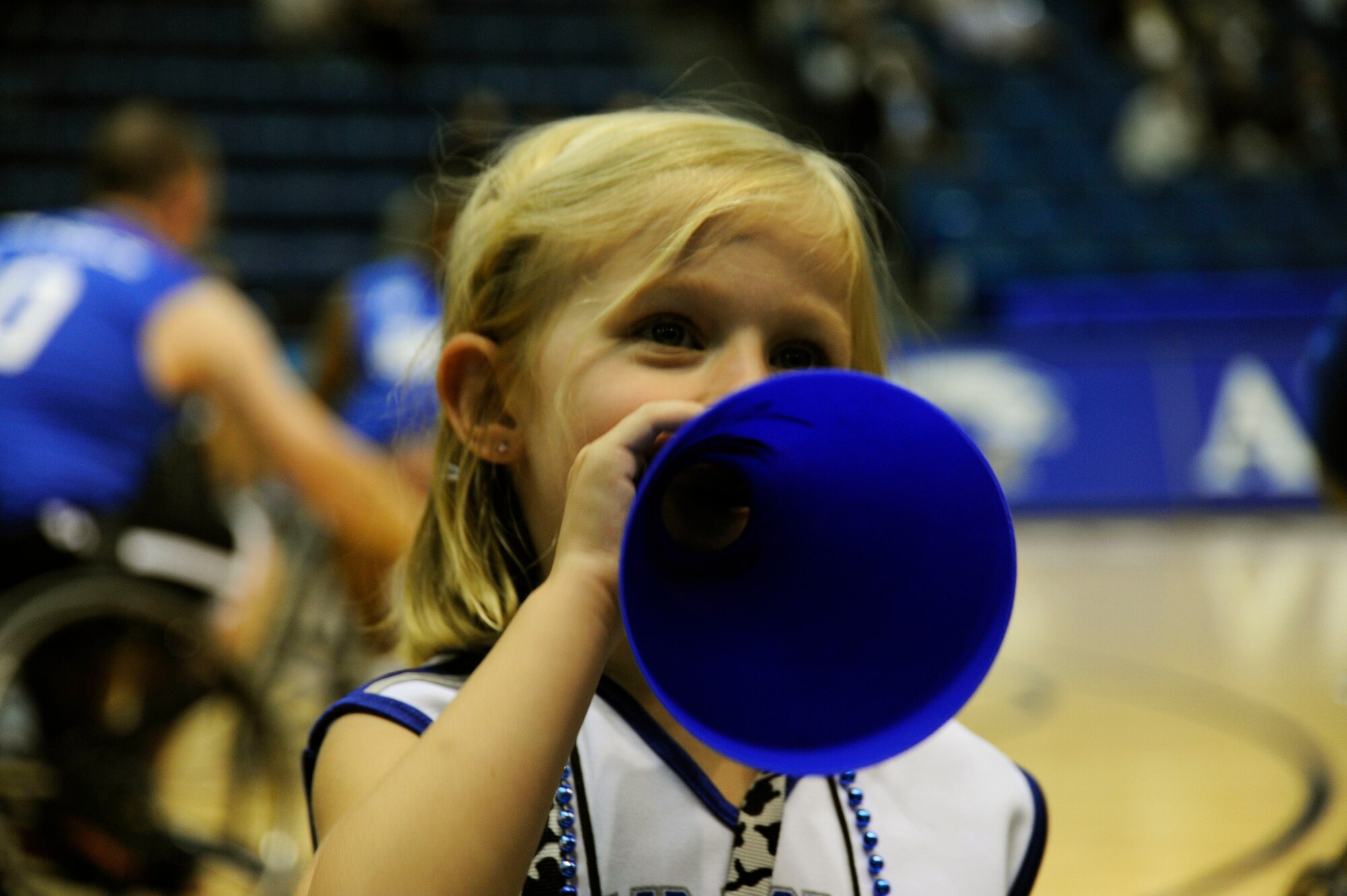 Air Force "cheerleader" Olivia Hassler, 4, yells to the crowd at a wheelchair basketball game May 1, 2012, during the Warrior Games at the U.S. Air Force Academy in Colorado Springs, Colo. Olivia helped cheer the Air Force team to victory against the U.S. Special Operations Command team 41-14. (U.S. Air Force photo/Tech. Sgt. Mareshah Haynes)