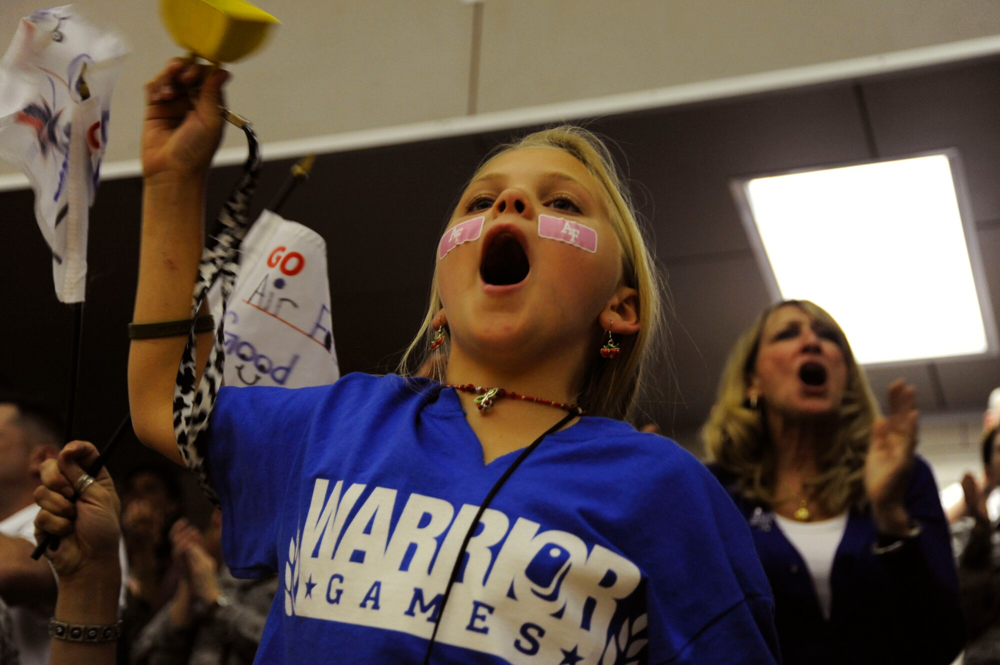 Nina Gestring cheers for her father May 1, 2012, during the Warrior Games at the U.S. Air Force Academy in Colorado Springs, Colo. Nina's father, Ken Gestring, is a member of the Air Force sitting volleyball team. The Air Force beat their opponent in consecutive matches. (U.S. Air Force photo/Tech. Sgt. Mareshah Haynes)