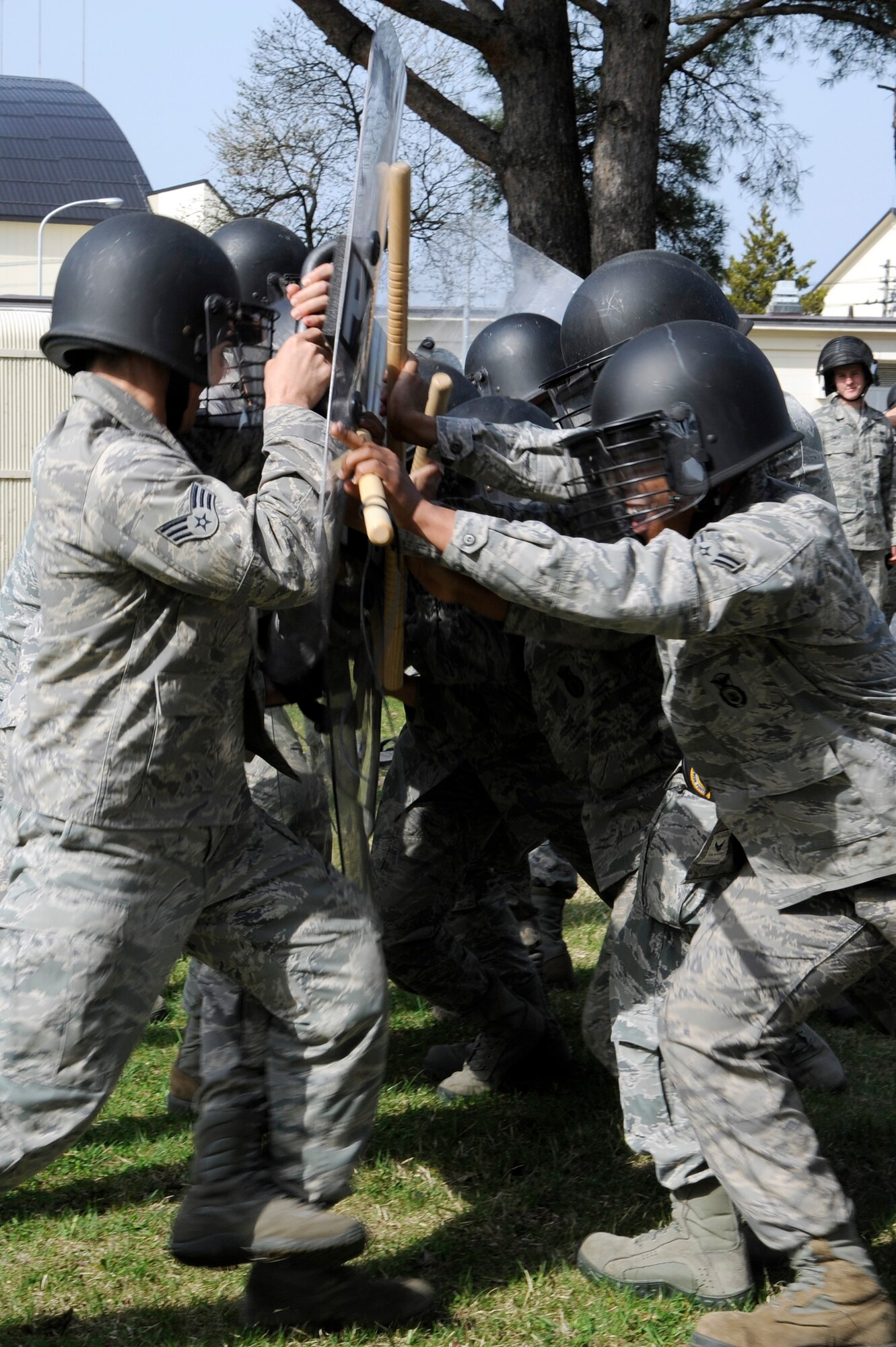 A dispersement team, right, consisting of U.S. Airmen with the 35th Security Forces Squadron tries to break through a simulated crowd during crowd control training at Misawa Air Base, Japan, April 28, 2012. A dispersement team will become defensive when a crowd penetrates a perimeter or becomes a threat. (U.S. Air Force photo by Tech. Sgt. Marie Brown/Released)
