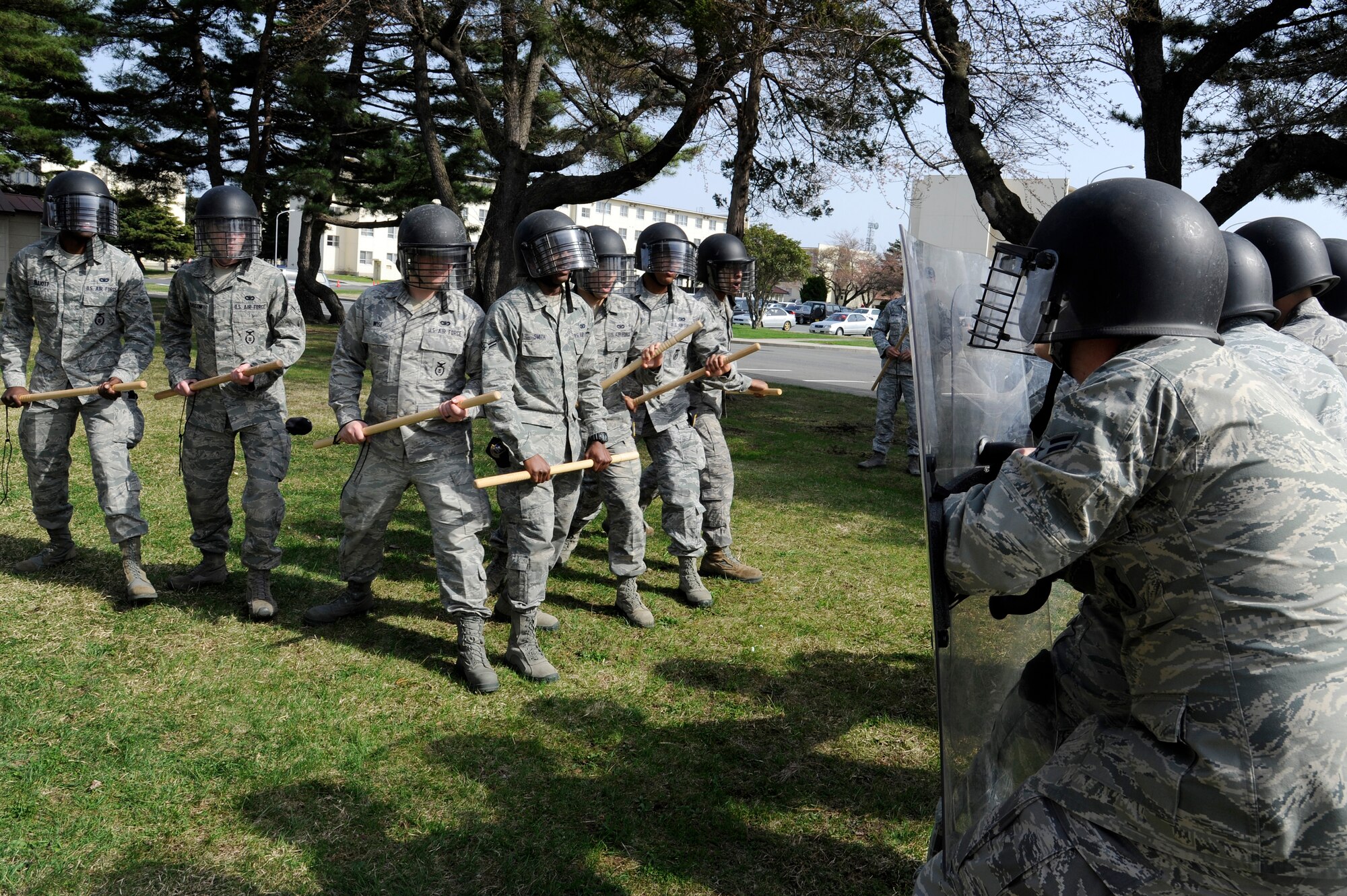 U.S. Airmen with the 35th Security Forces Squadron make a wedge formation during crowd control training at Misawa Air Base, Japan, April 28, 2012. The wedge formation is used to move the team through a crowd. The 35 SFS conducts various training exercises to keep defenders proficient at performing law enforcement duties. (U.S. Air Force photo by Tech. Sgt. Marie Brown/Released)
