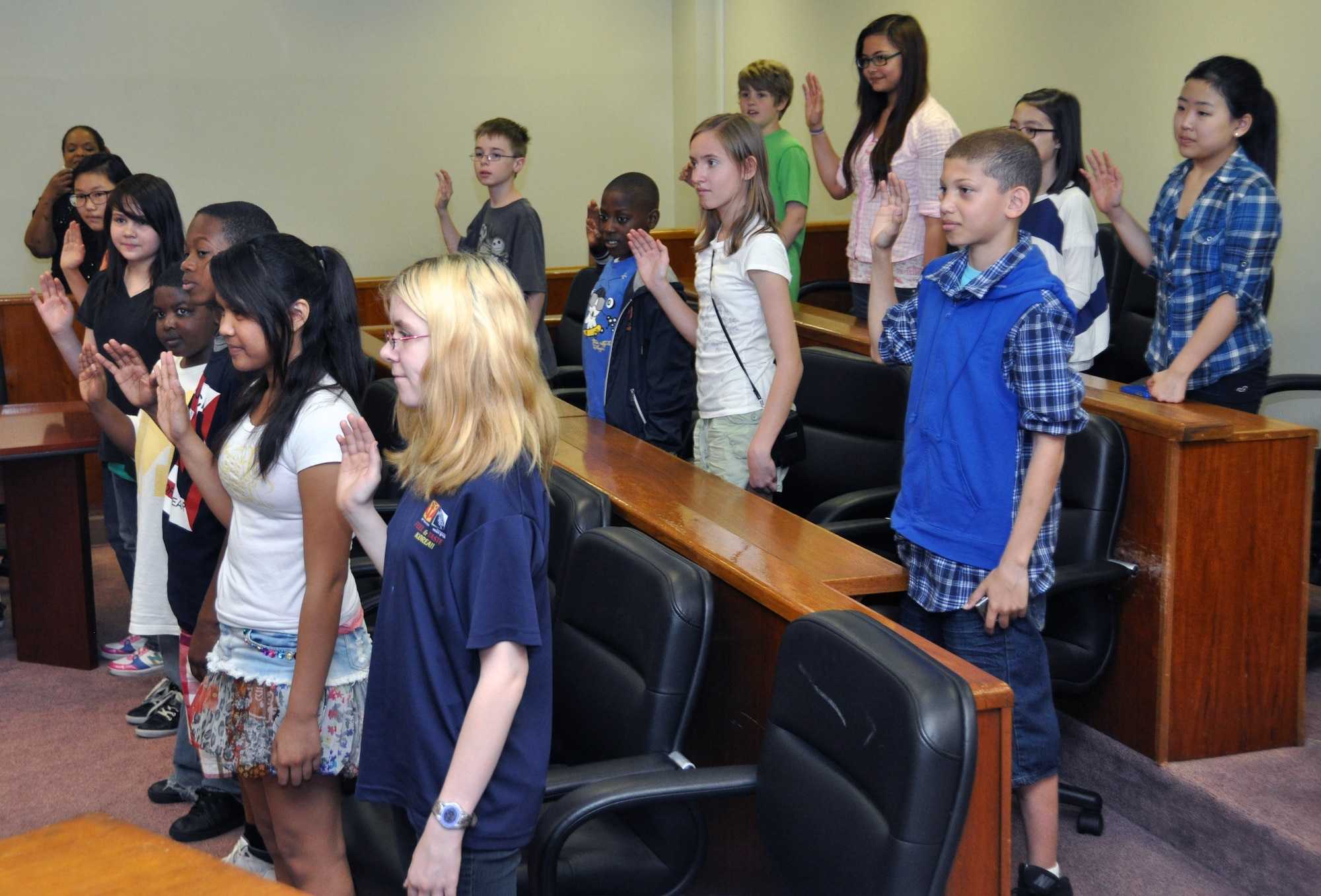 Sixth graders from Osan Middle School are sworn in as members of a jury during a mock trial at Osan Air Base, Republic of Korea, May 1, 2012. The 51st Fighter Wing Staff Judge Advocate Office hosted approximately 30 students from OMS to take part in Law Day. Every year, legal officials have used Law Day as an opportunity to educate the community on the legal system, courtroom and how the law is used to protect Constitutional rights. (U.S. Air Force photo/Airman 1st Class Michael Battles)