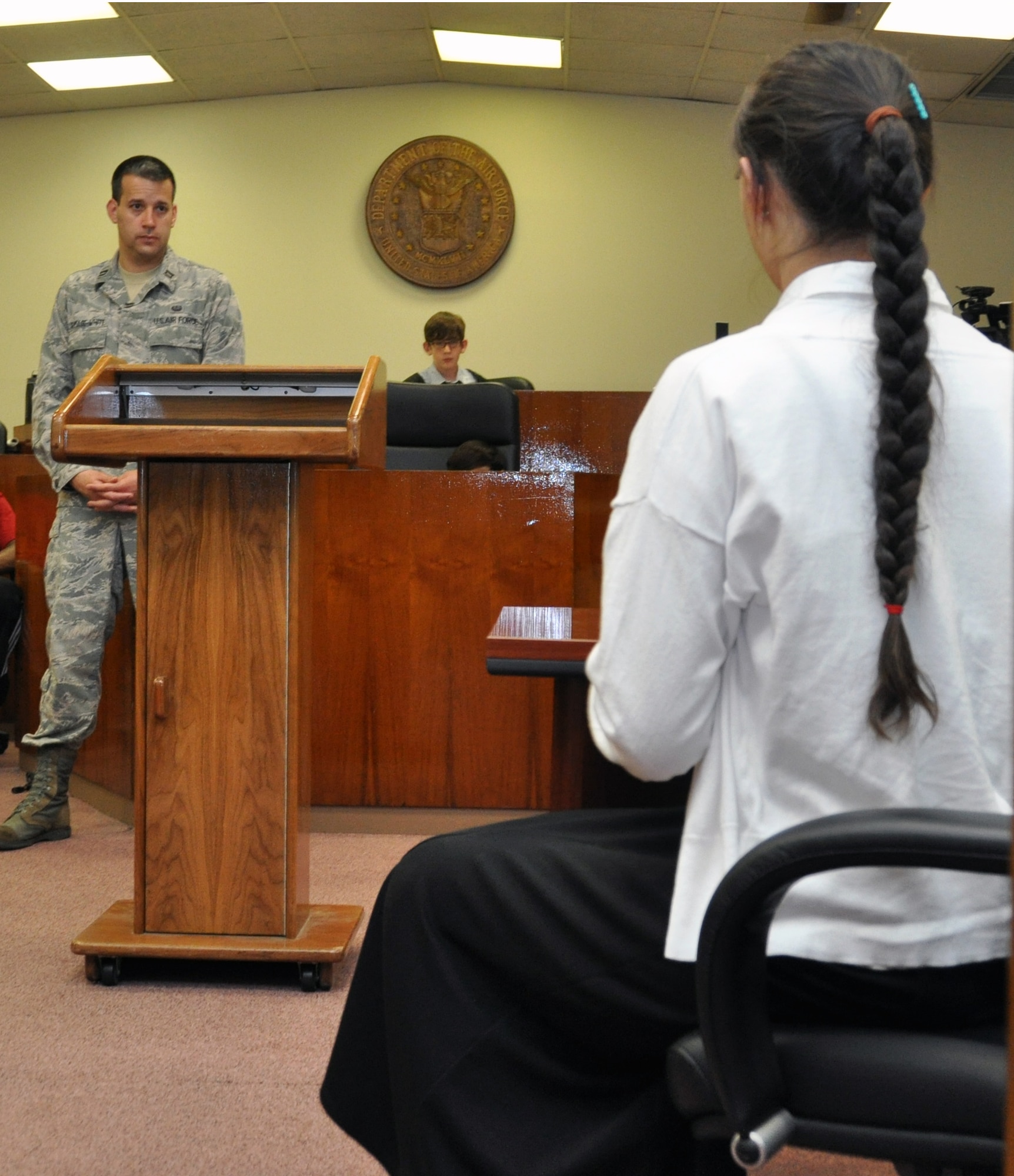 Sun Hee Maxfield, a 12- year-old student at Osan Middle School, states her case to Capt. Matthew Ramage-White, 51st Fighter Wing assistant judge advocate, during a mock trial scenario “The stolen car” at Osan Air Base, Republic of Korea, May 1, 2012. Maxfield acted as the defending attorney during the mock trial. (U.S. Air Force photo/Airman 1st Class Michael Battles)